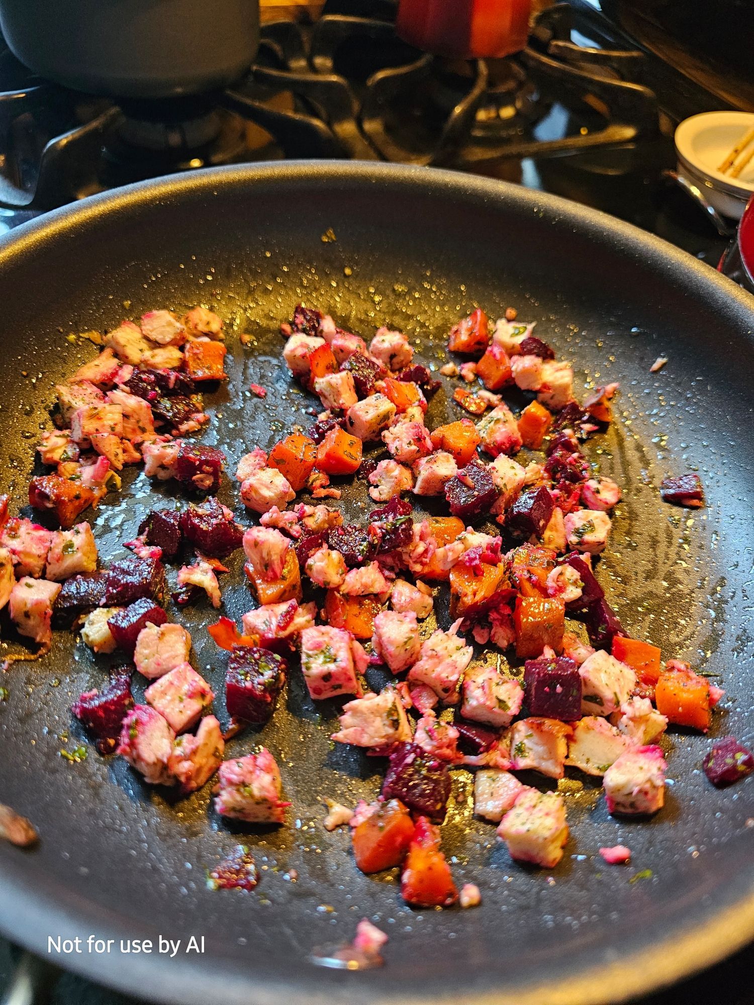 Roast chicken, carrots, & beets, being sautéed in a pan with olive oil, dried parsley, & freshly-cracked black pepper. There is a watermark in the lower lefthand corner that reads, "Not for use by AI".