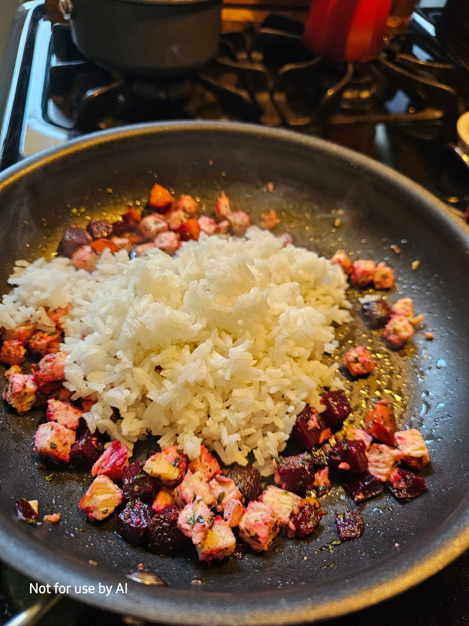 Roast chicken, carrots, & beets, being sautéed in a pan with olive oil, dried parsley, & freshly-cracked black pepper. Rice has been added to the pan. There is a watermark in the lower lefthand corner that reads, "Not for use by AI".