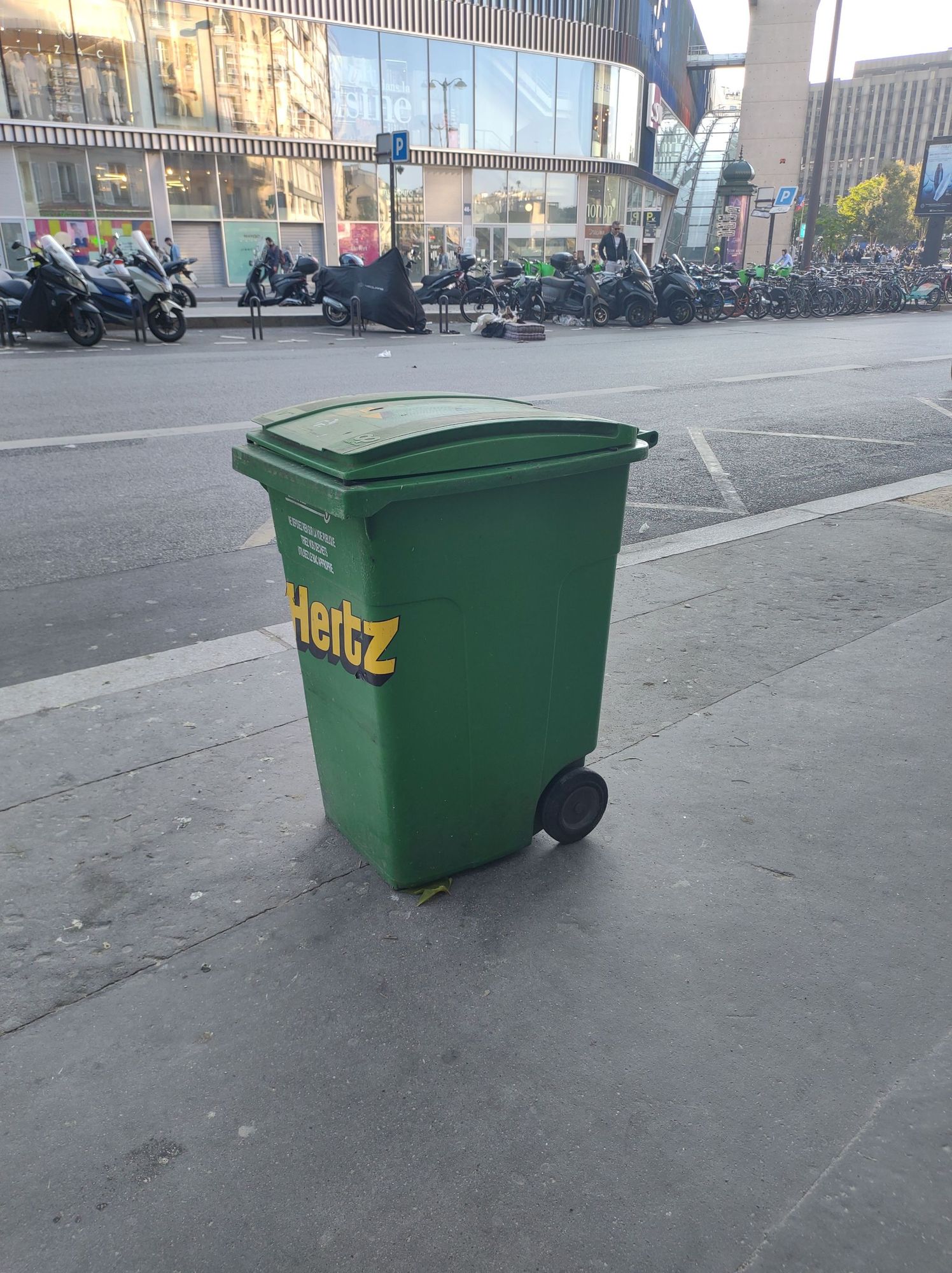 Green toter trash bin in Paris