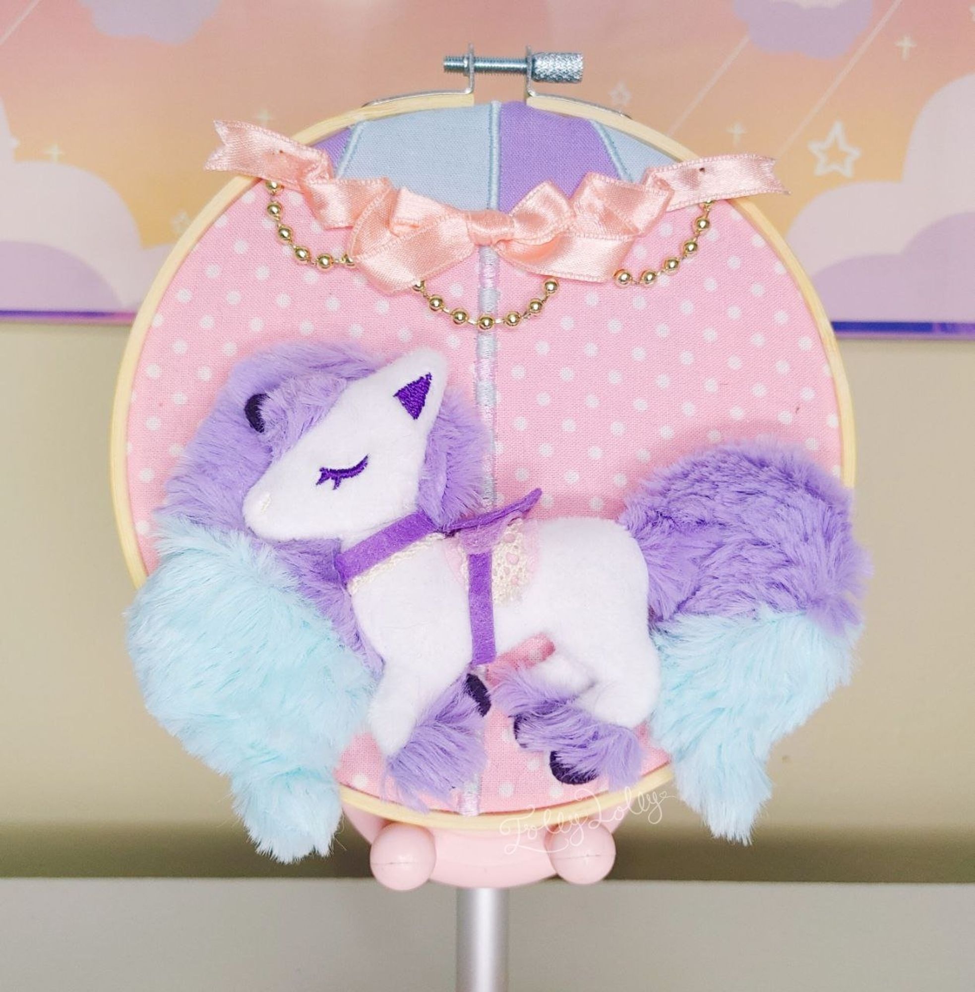 An embroidery hoop with a 3D carousel horse styled Galarian Ponyta design