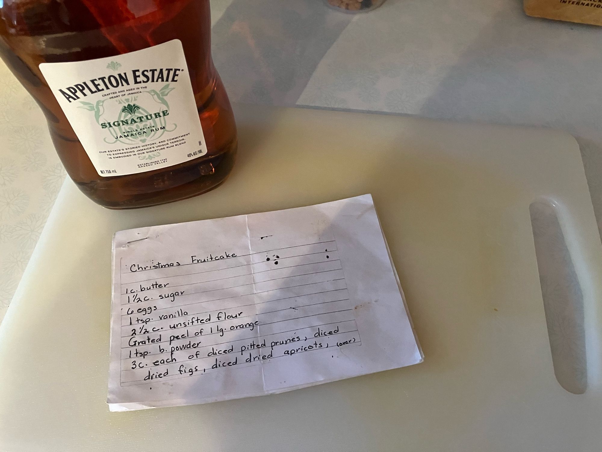 A bottle of Rum and a photocopy of a Fruitcake recipe