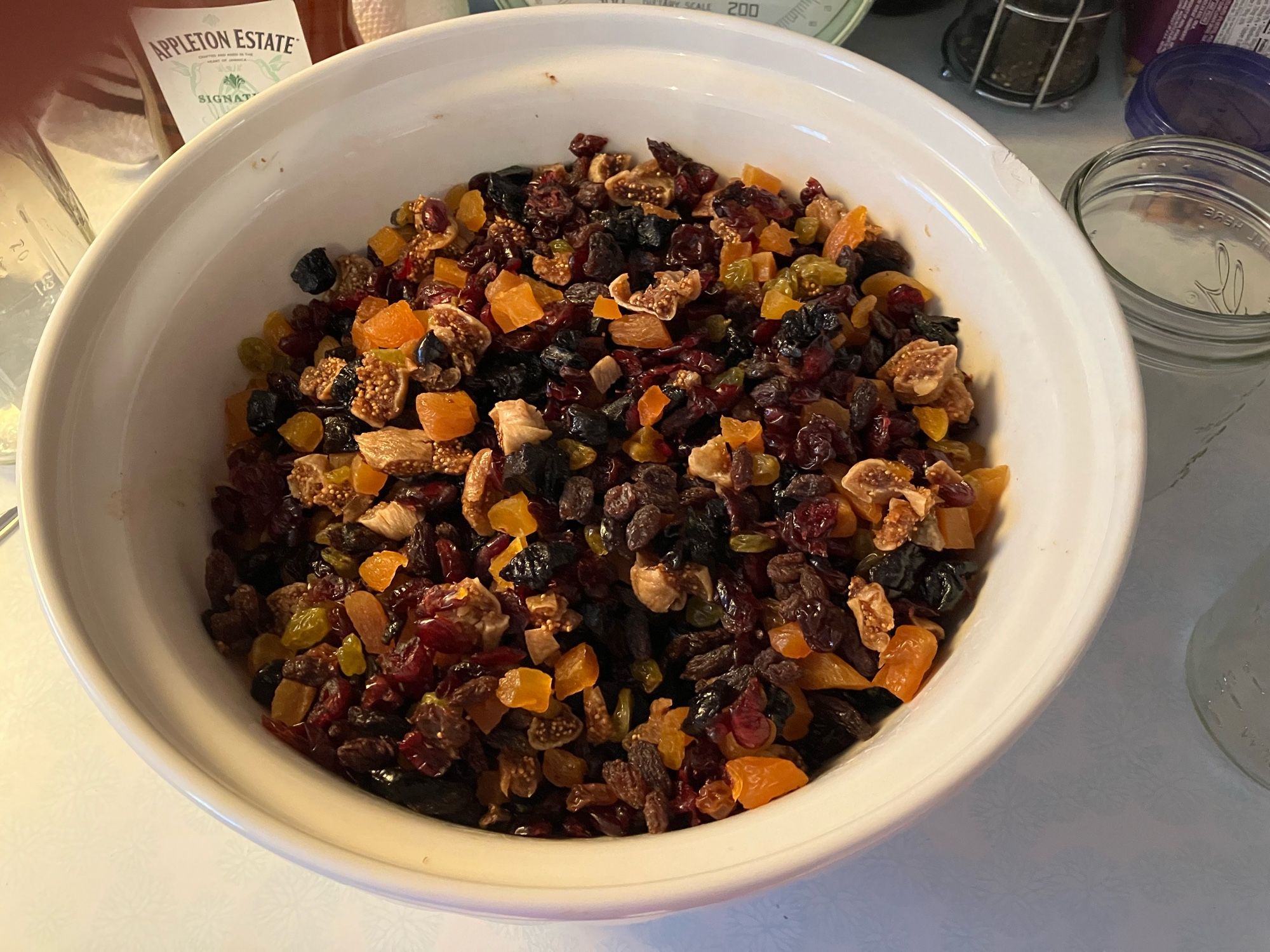 A bowl containing about 5lbs of chopped dried fruit, Dark Raisins, yellow raisins, apricots, cherries, cranberries and figs.