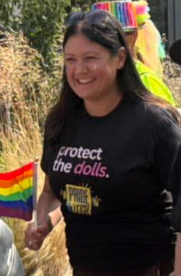 Lisa Nandy in a Pride parade wearing a black shirt with text saying “Protect the dolls”.