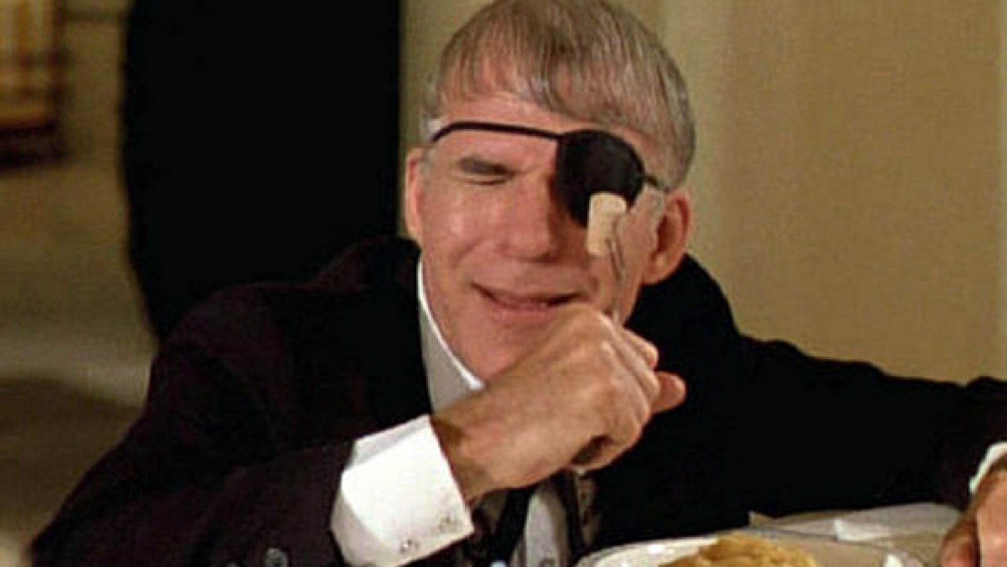 Steve Martin, in the movie “Dirty Rotten Scoundrels”, stabbing a fork—tines protected by a cork—towards his patch-covered left eye.