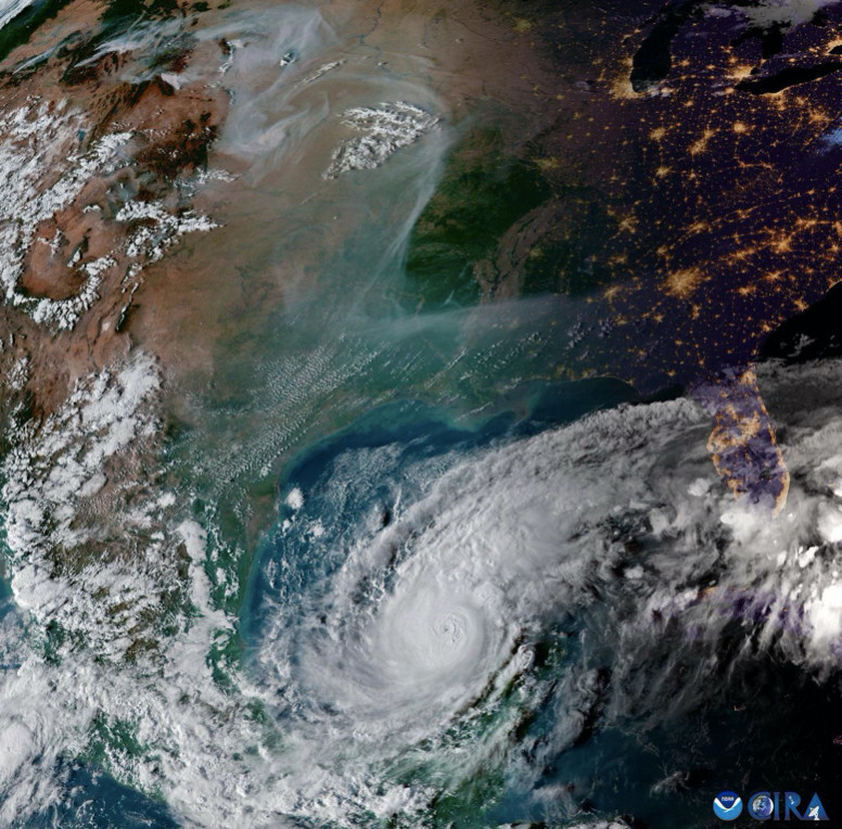 Satellite image showing the southern and central part of the US. Evening of Oct 8th. The western part is in sunlight, but the Midwest ad east coast are in darkness, with city lights showing. Hurricane Milton is in the Gulf of Mexico. There is some wispy wildfire smoke over the central US.