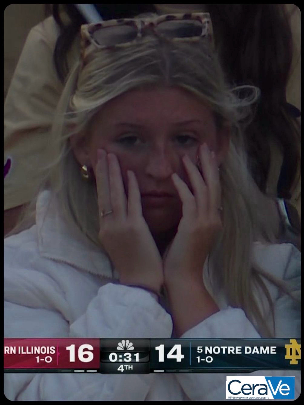 Football fan holding her hands up to her face in despair as her team loses. The score reads Northern Illinois 16, Notre Dame 14