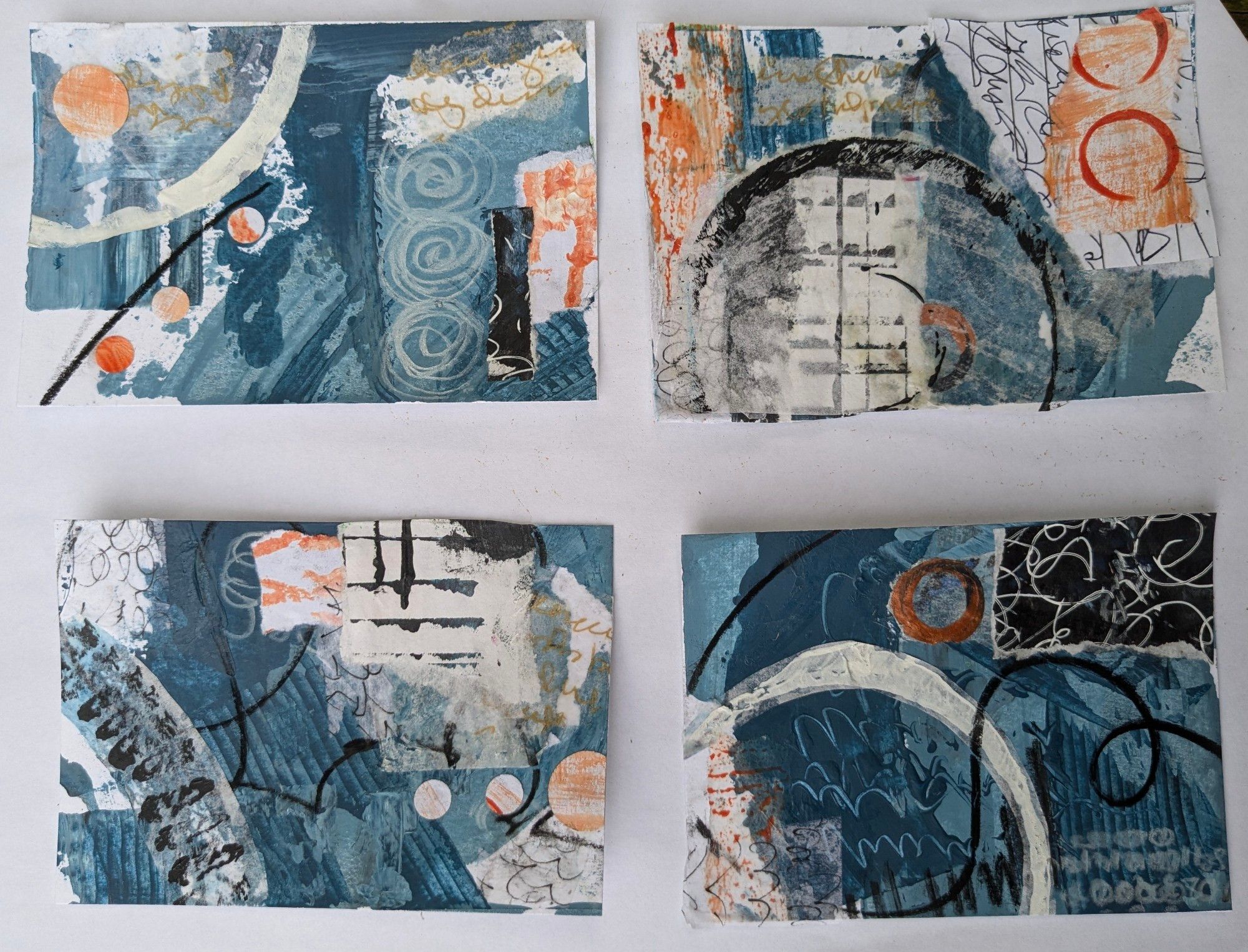 Four mixed media collage pieces with torn and textured paper in shades of blue, black, and white, a few bits of orange and pieces of asemic writing