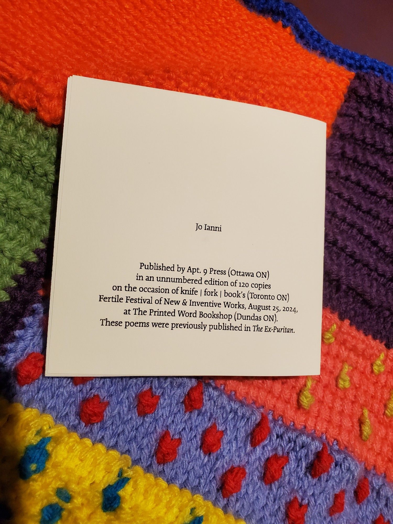 Special edition poetry chapbook FO/UR by Jo Ianni (Apt 9 Press) sits atop a colourful crocheted afghan, showing back/copyright/etc page