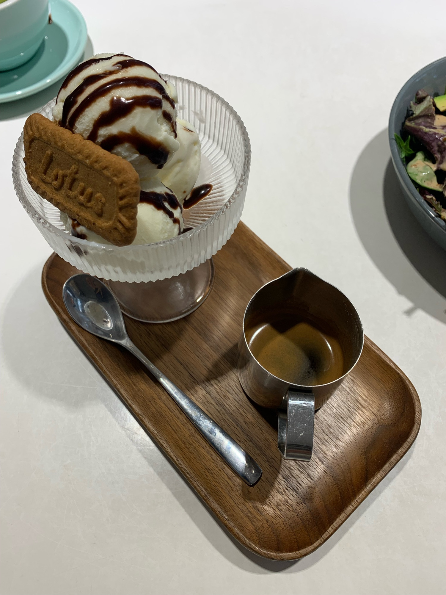 Affogato: a small cup of espresso, three scoops of vanilla ice-cream and a biscoff biscuit with it. 