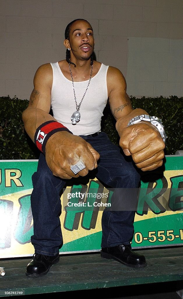 Ludacris having a sit (while wearing his giant arm prosthetics)