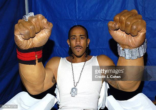 Ludacris holding his giant arm prosthetics up in the air