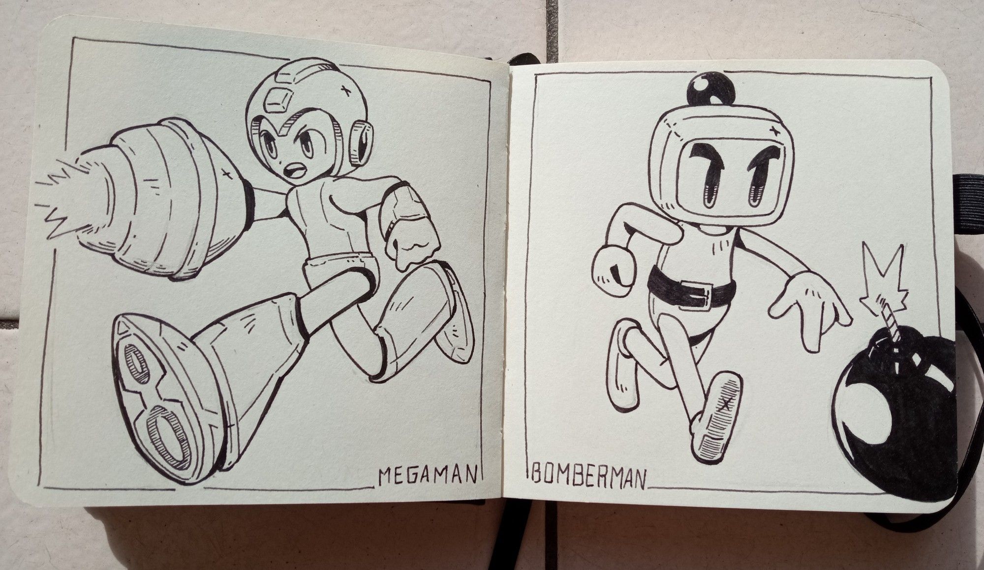 Double page de mon carnet. Sur la page de gauche, un dessin de Megaman, sur celle de droite, un dessin de Bomberman. Stylo-plume et feutre-pinceau