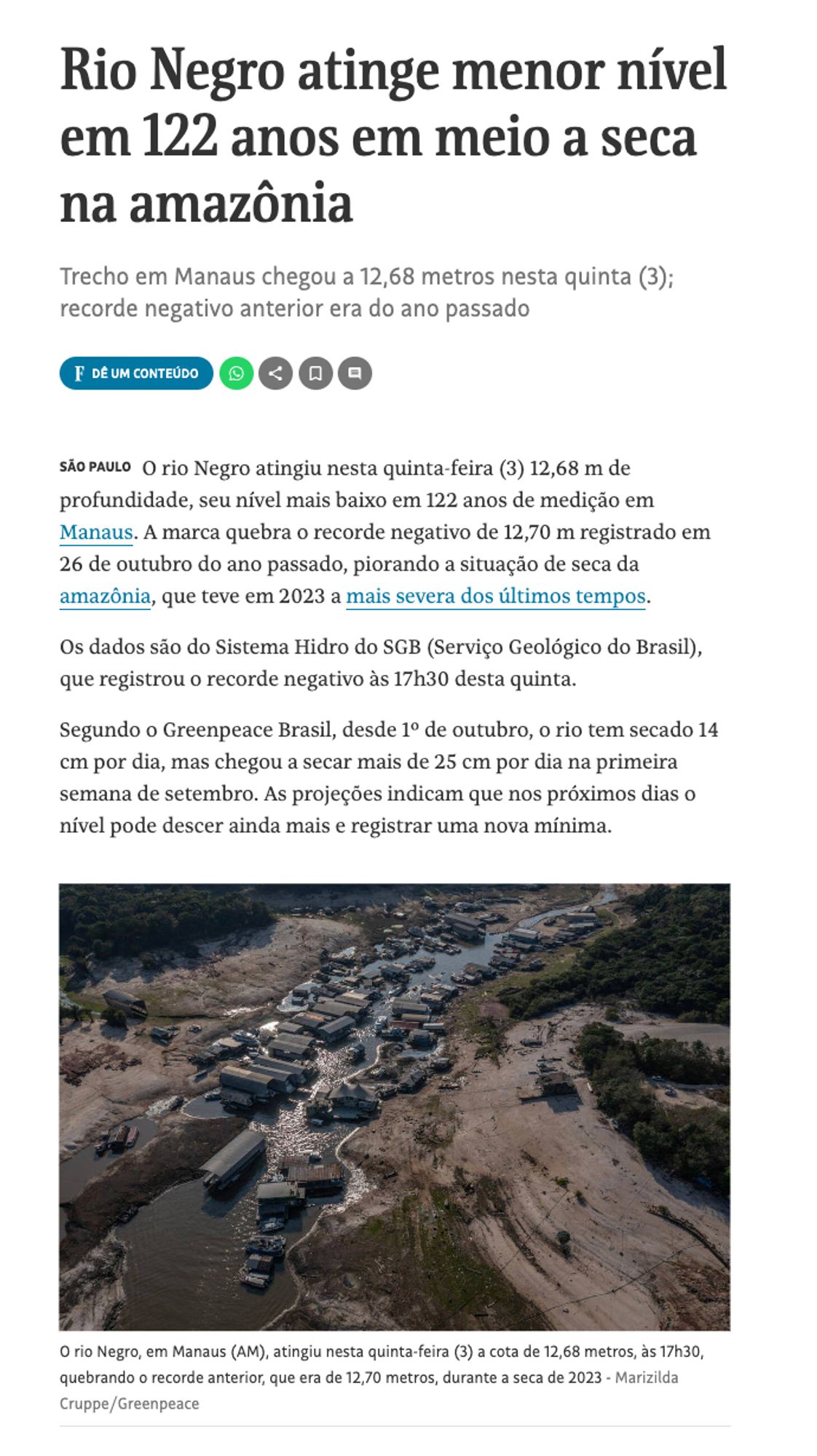 Imagem de parte de uma matéria data Folha de São Paulo de 26 de outubro de 2024 diz "Rio Negro atinge menor nível em 122 anos em meio a seca na amazônia". No início da matéria tem uma imagem do rio seco cheio de barcos ancorados no fio de água que restou. 