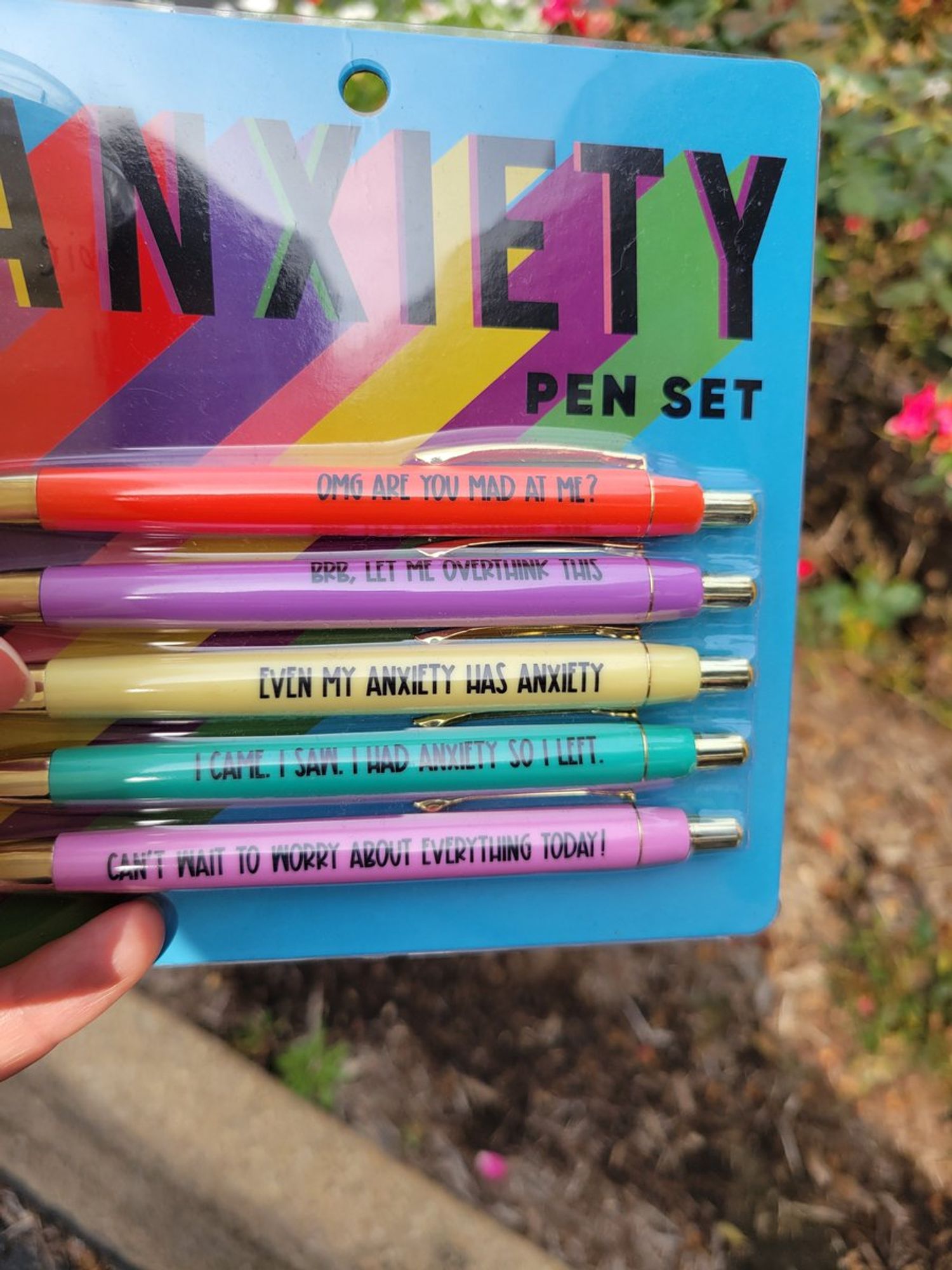 Anxiety Pen Set

- Red one says "OMG are you mad at me?"
- Purple one says  "BRB, let me overthink this."
- Yellow one says "Even my anxiety has anxiety."
- Greenish one says "I came, I saw, I had anxiety so I left."
- Pink one says "Can't wait to worry about everything today!"