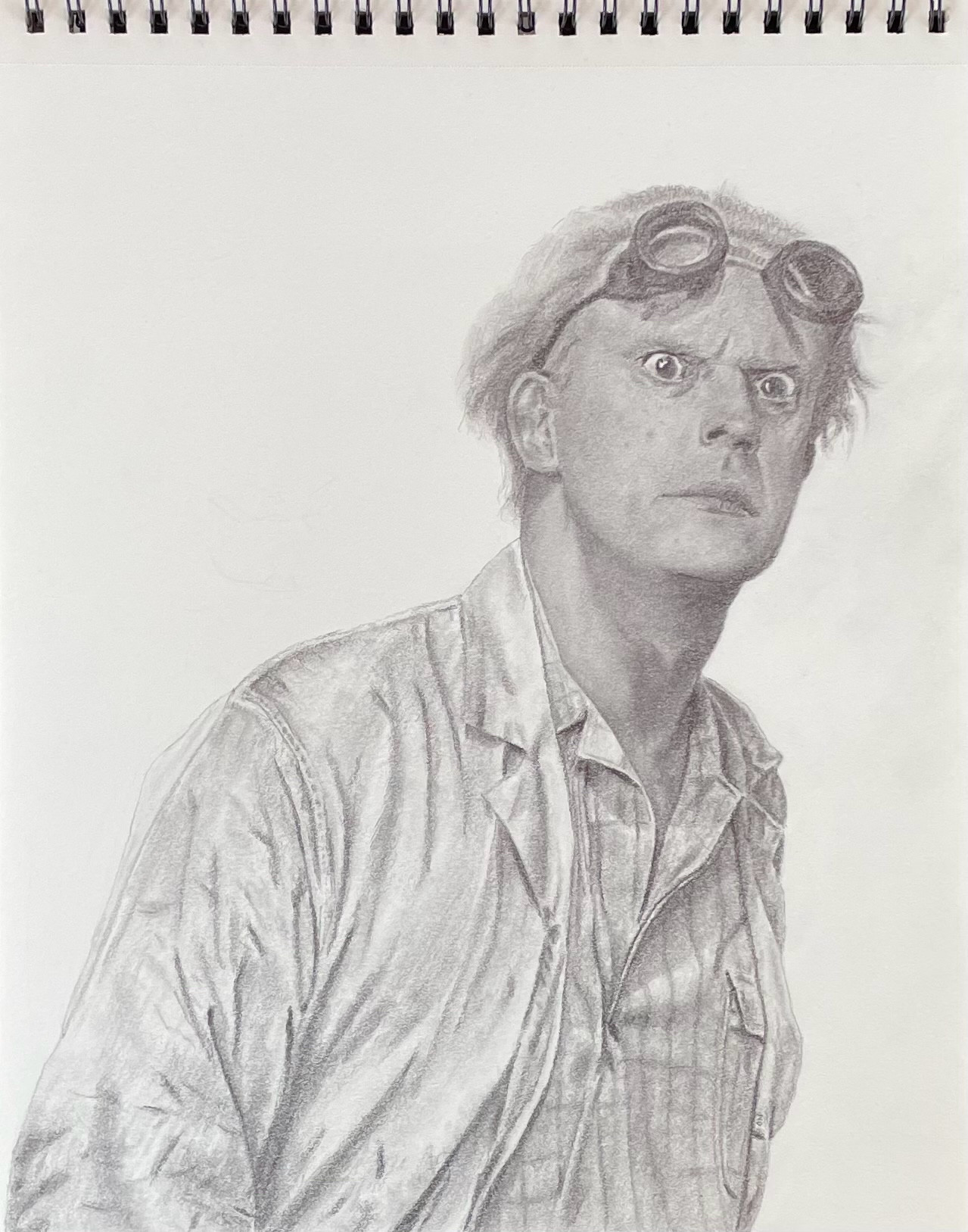 Doc Brown with a disapproving expression. 
Pencil and paper. 