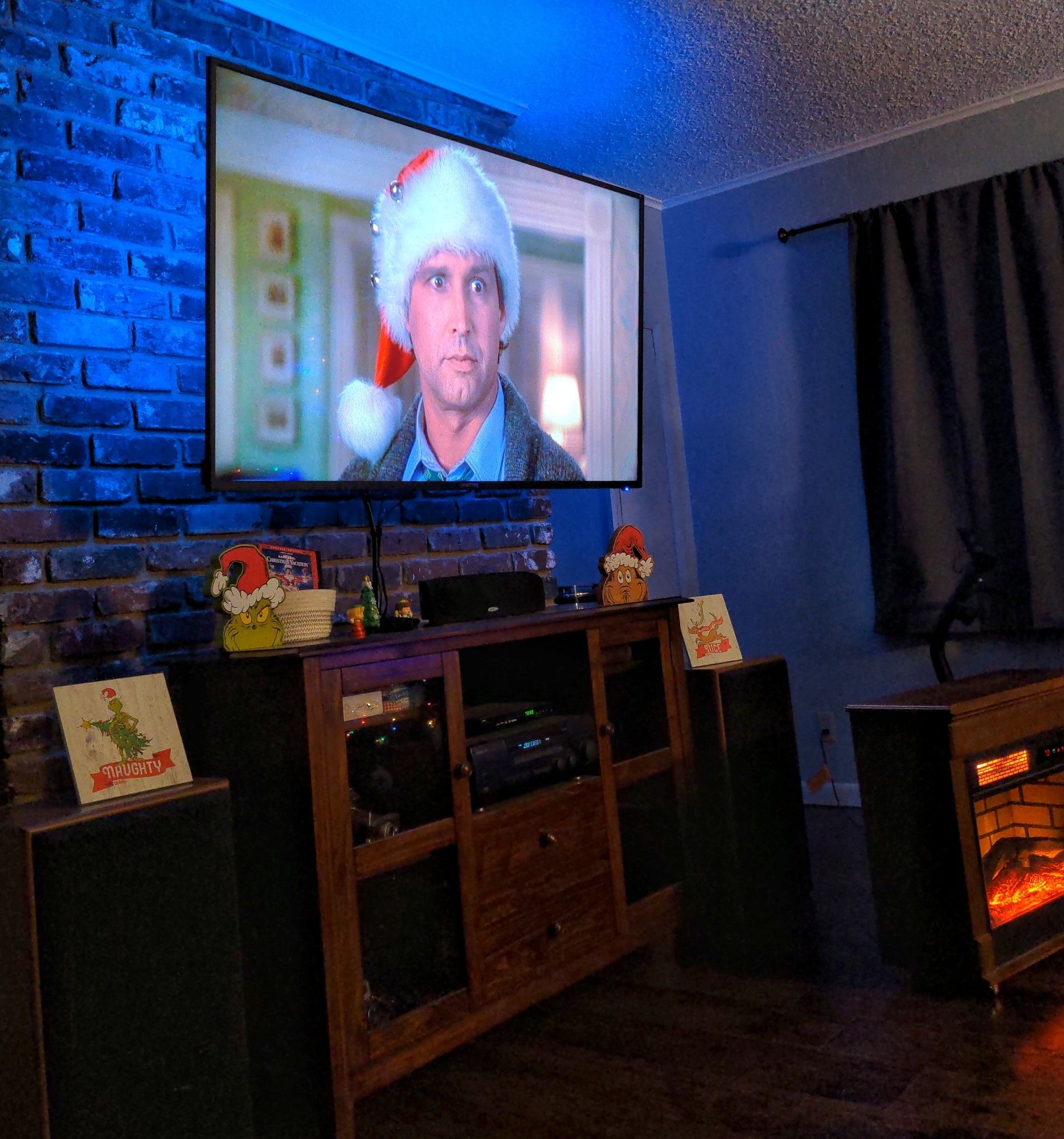 Still image of perennial Christmas movie classic, Christmas Vacation, showing Clark Griswold wearing a Santa hat.