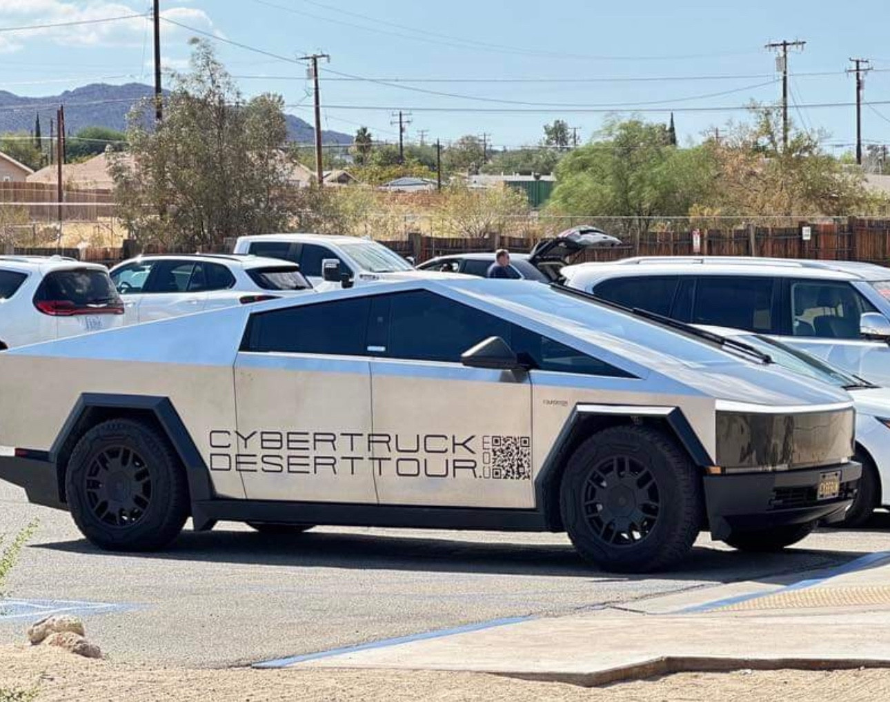 “Cybertruck Desert Tour” on side of a cybertruck parked outside the Joshua Tree National Park Visitor Center 