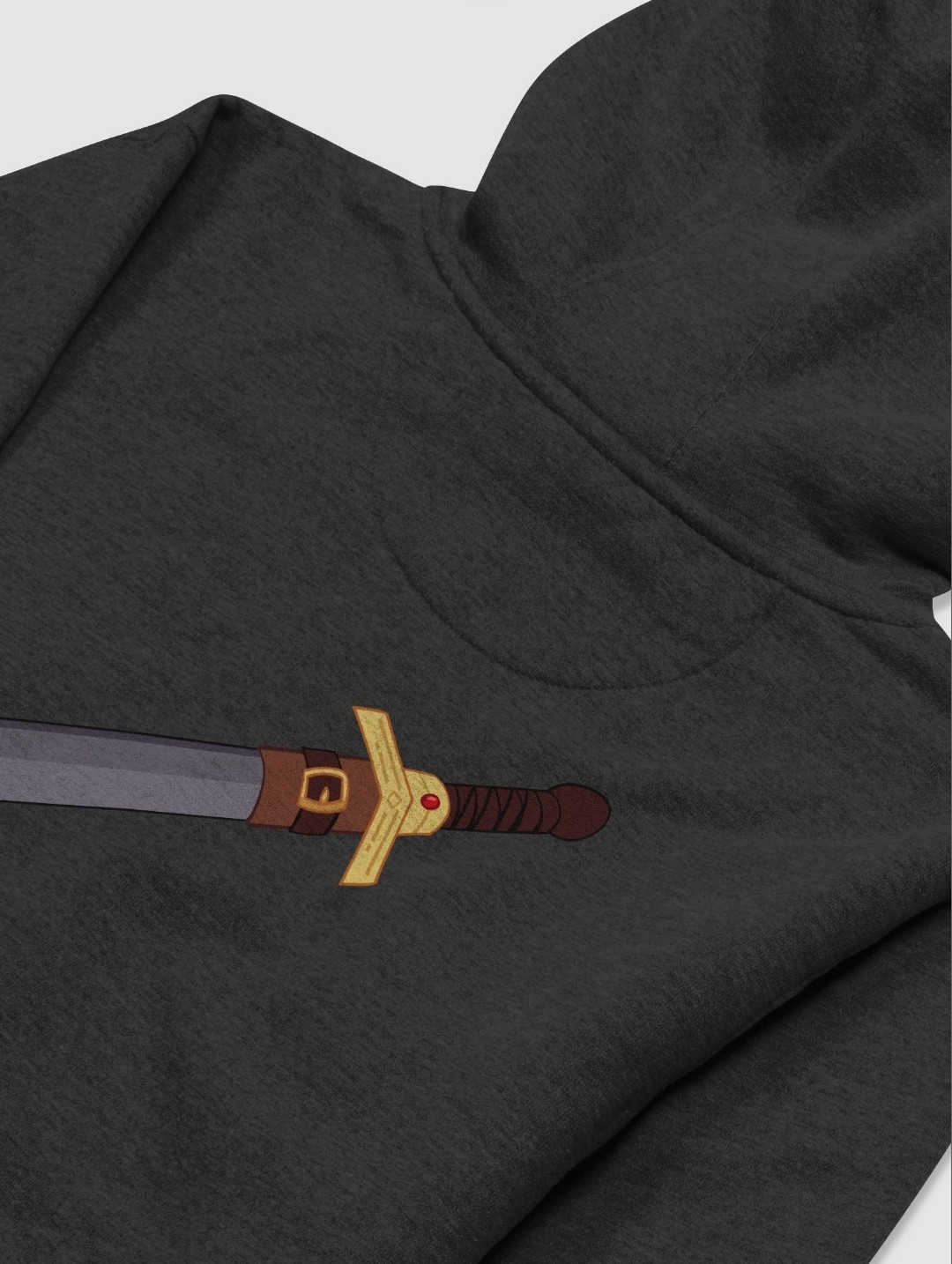 A hoodie facing down with a design of a sword on the back. The sword has a leather-wrapped handle and a leather sheath covering part of the metal blade.