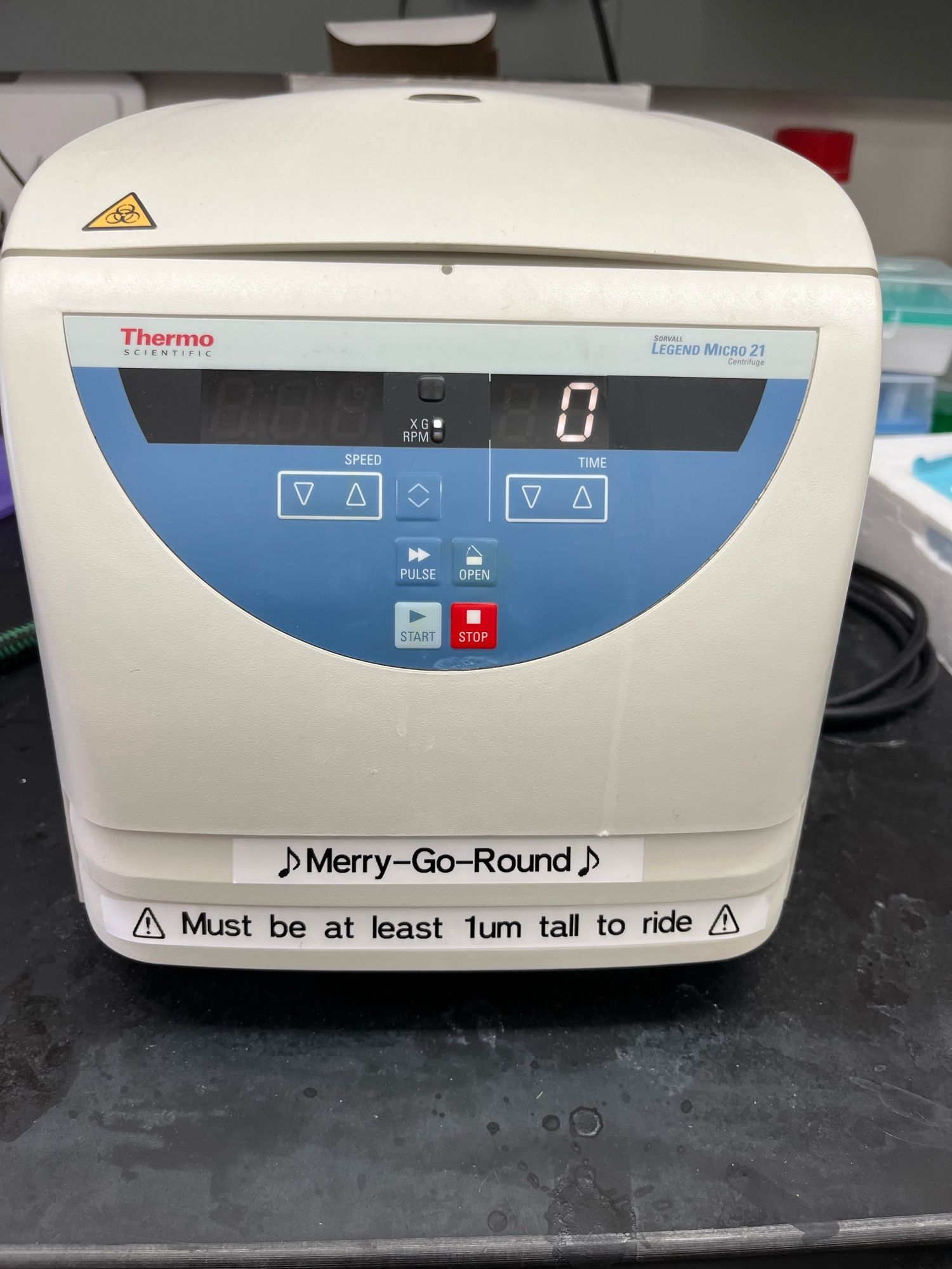 A microcentrifuge with labels on it saying “merry-go-round” and “must be at least 1um tall to ride”