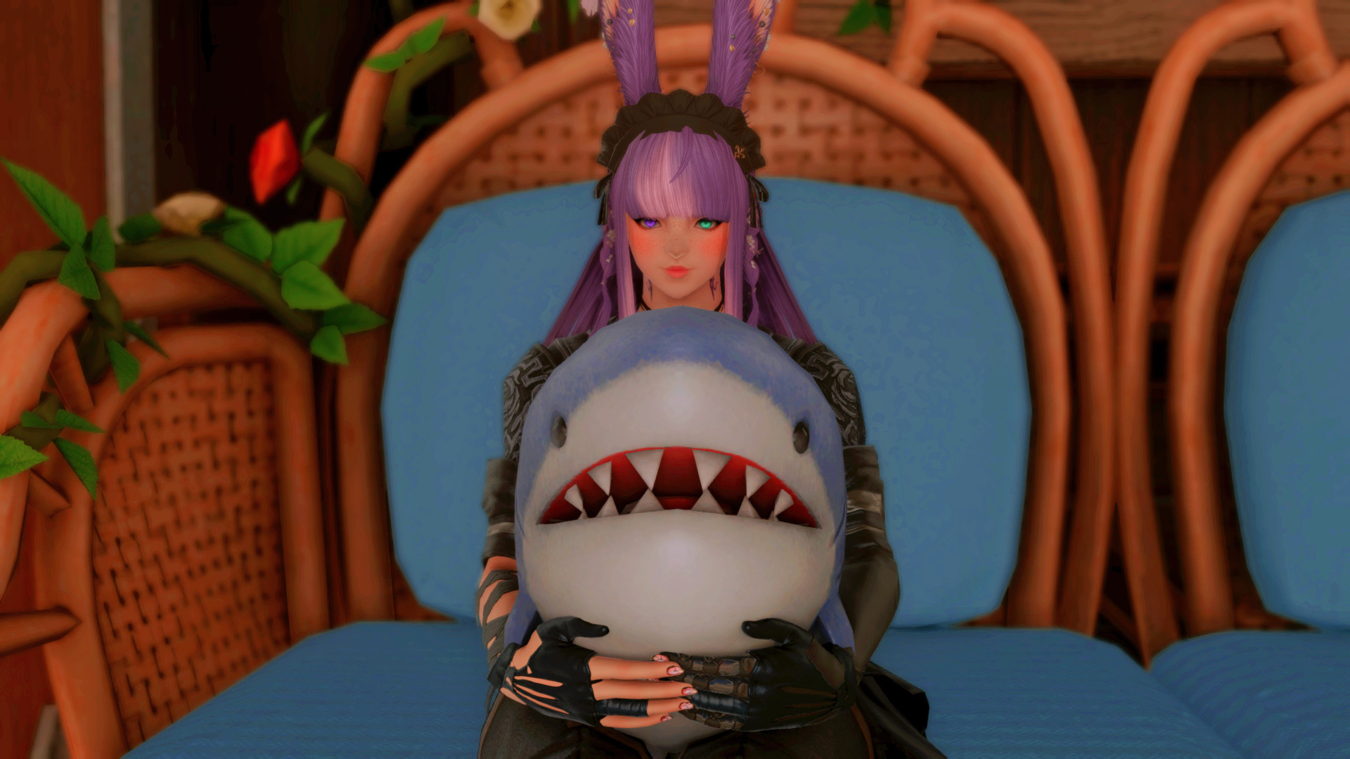 a young woman holding a plush shark while seated on a large blue couch. both she and the shark are facing towards the viewer. her hair is purple with pink highlights, and she has a pair of barely-visible rabbit ears. her left eye is green, and her right is purple.