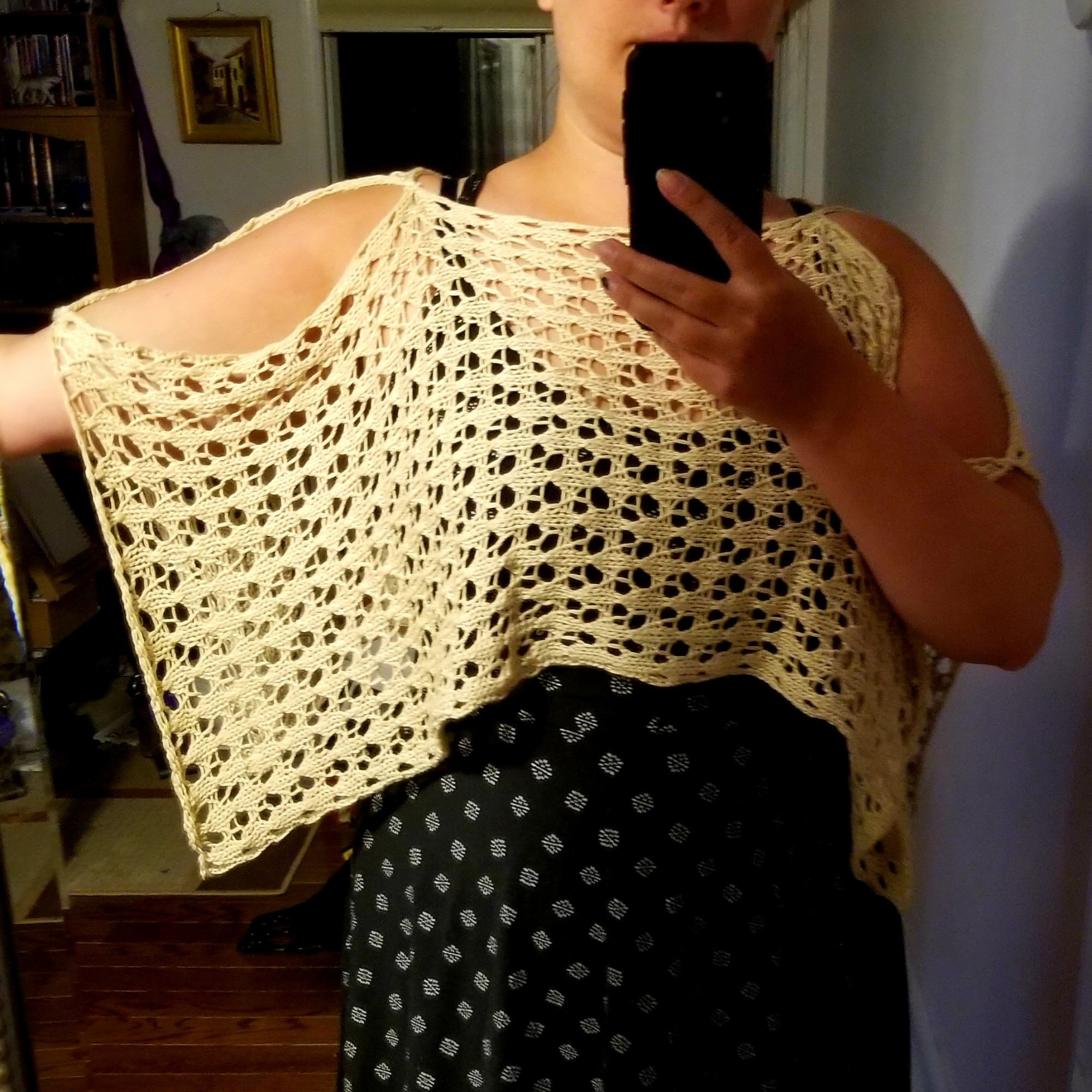 An off-white lace shawl with mid-length sleeves: front view