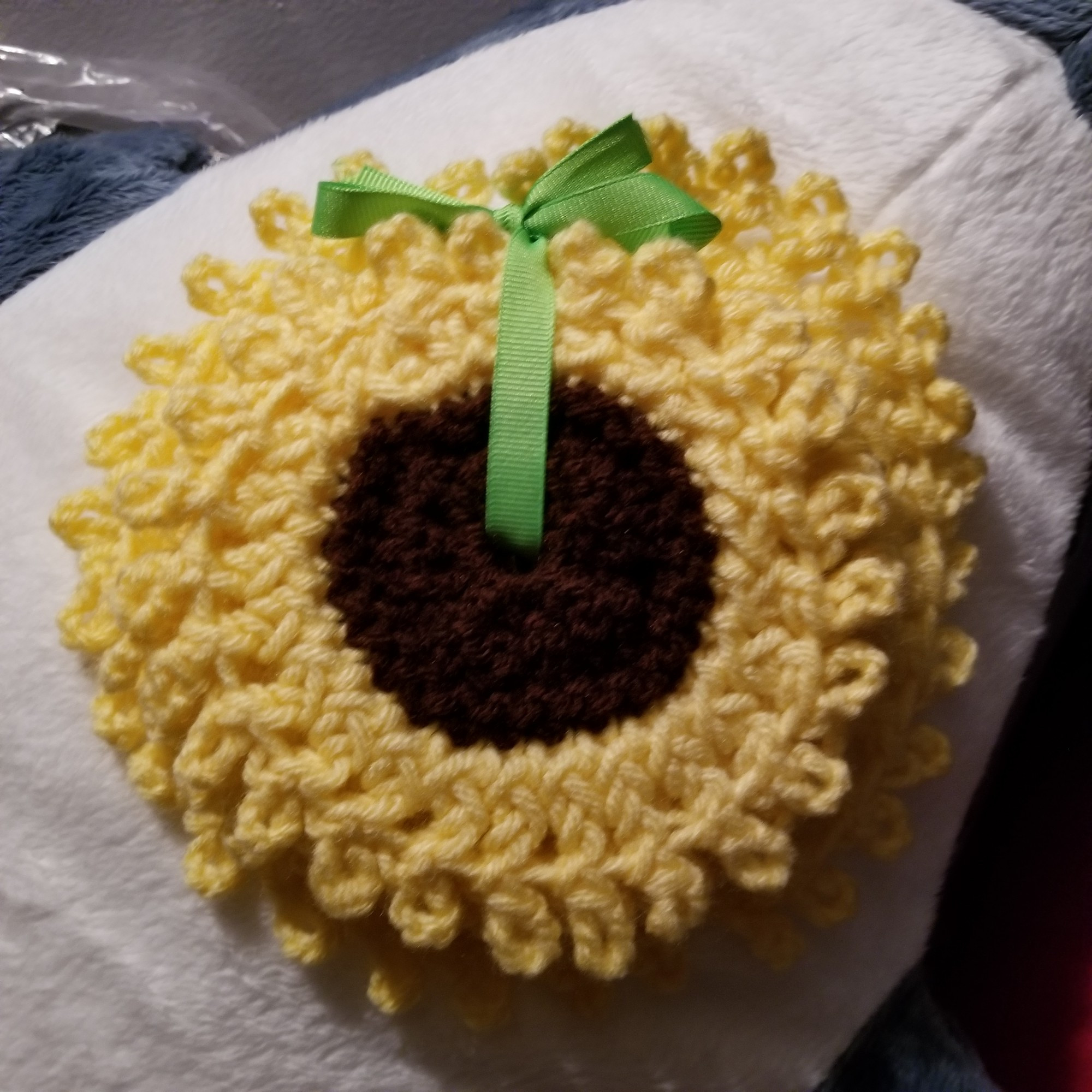 A bundle of sunflower shaped lacy coasters, tied together with light green ribbon.