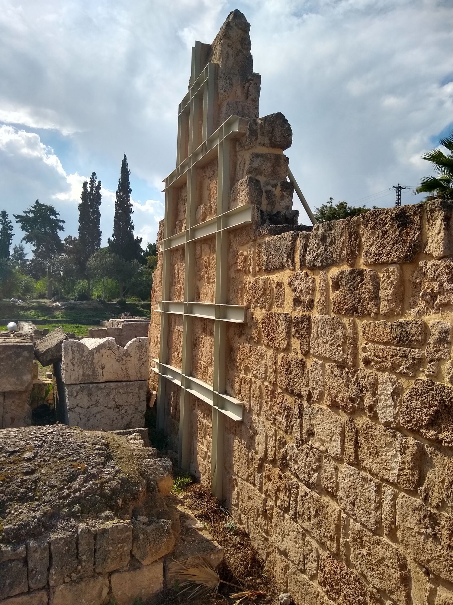 Here's an ancient wall that has modern support beams reinforcing it without blocking your view of the old masonry