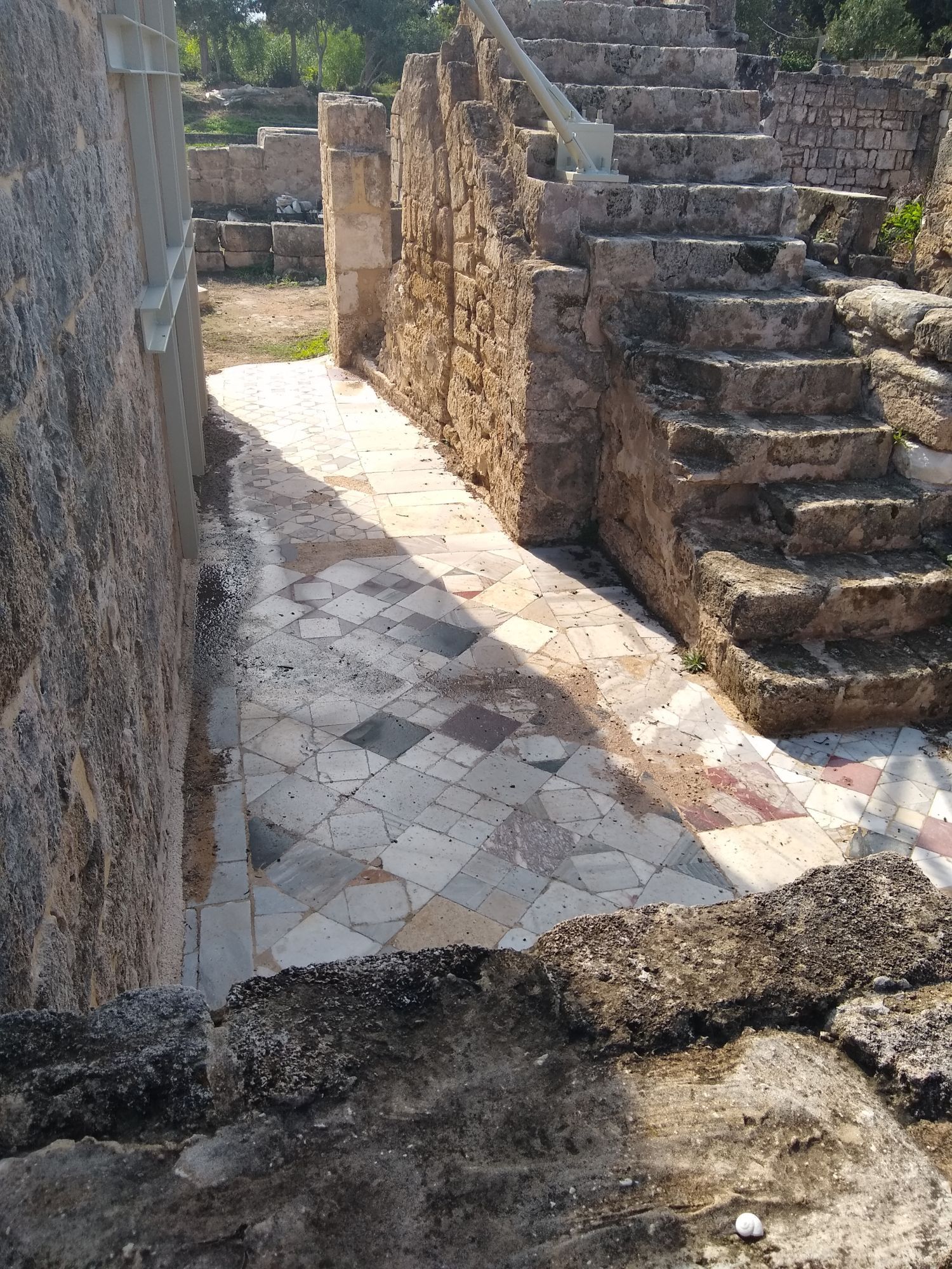 cool ancient marble tile floor (large squares much like modern floors) next to an ancient staircase