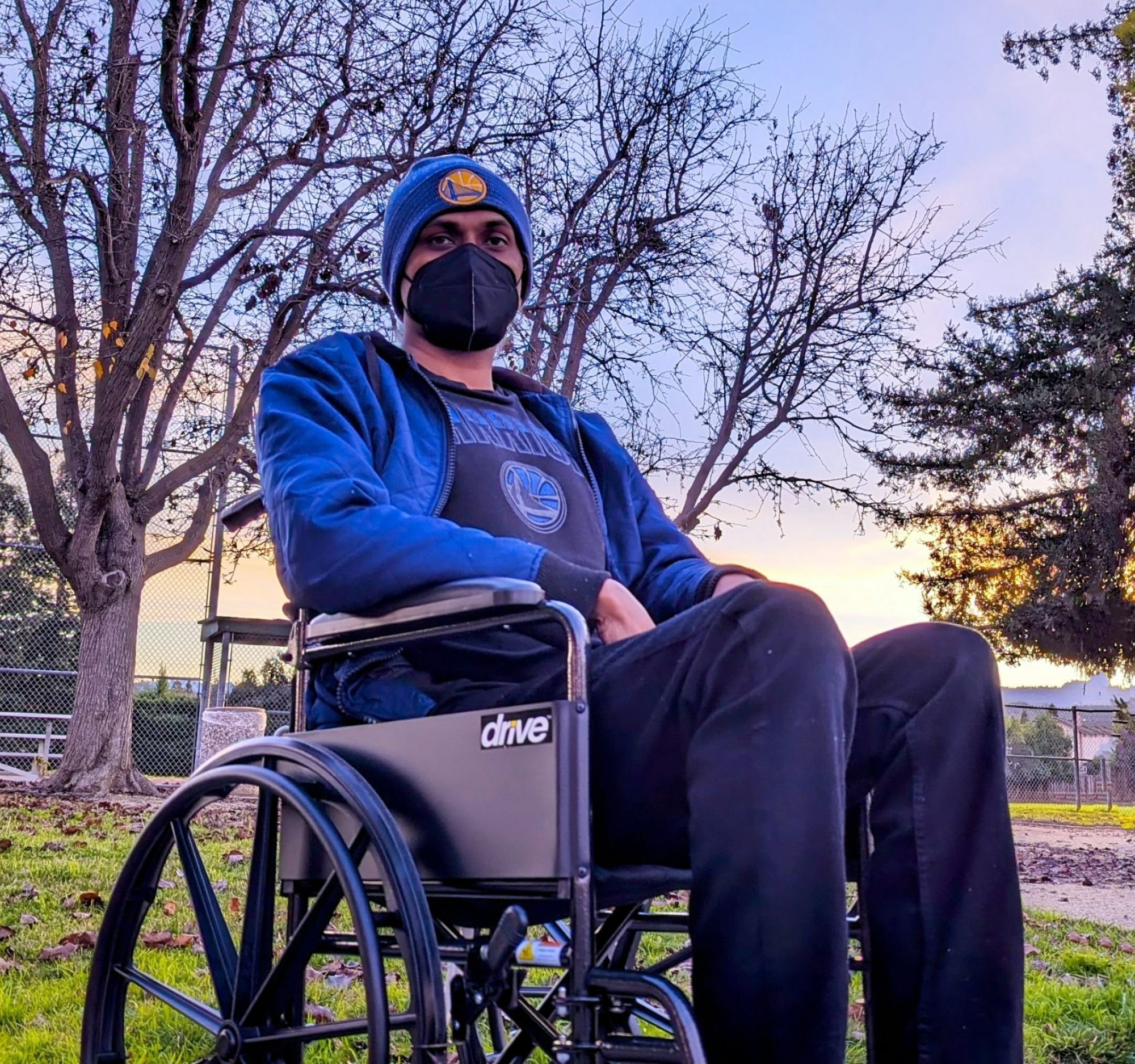 [image by Nima Slone of Ravi Valleti wearing a KN95 mask while in his wonderful new wheelchair at a SF Bay Area park]