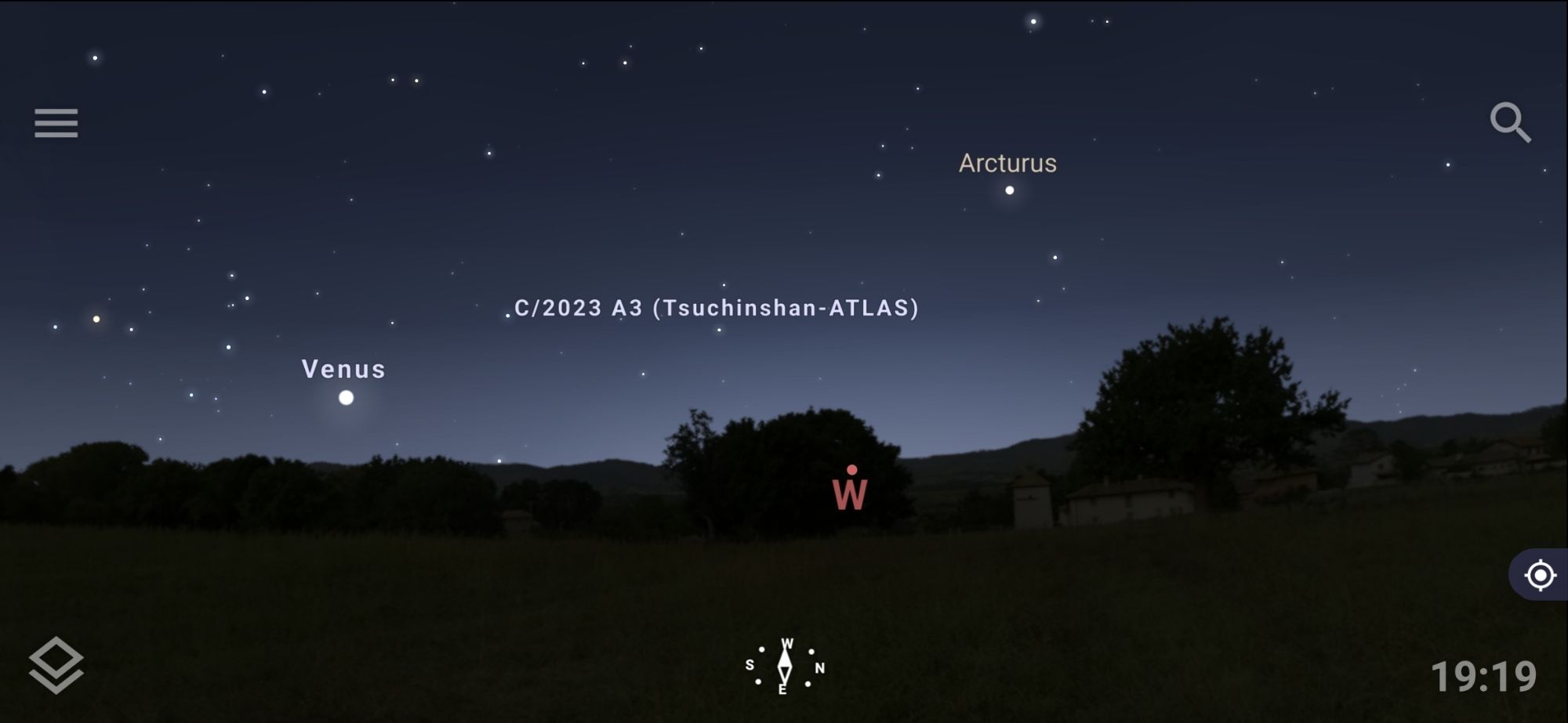 A screenshot of the smartphone app Stellarium showing the starscape for my time and location. The ground is on the bottom to show the horizon line, and Venus is identified on the left in the direction my phone is pointing. Arcturus is identified higher and off to the right. And between those two is a label for the comet C/2023 A3 (Tsuchinshan-ATLAS)