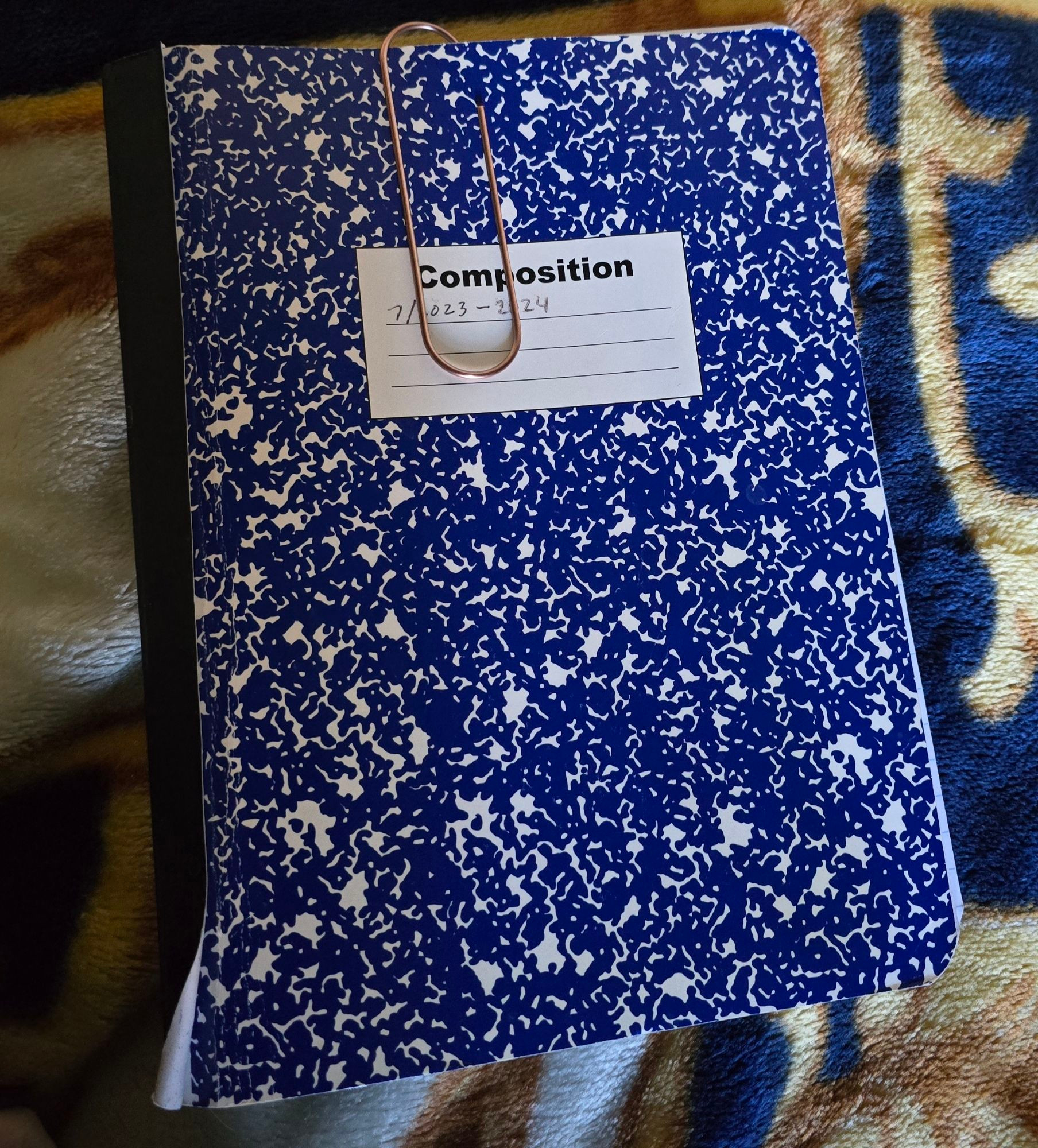 blue marble composition notebook i use as a journal. years 2023-2024