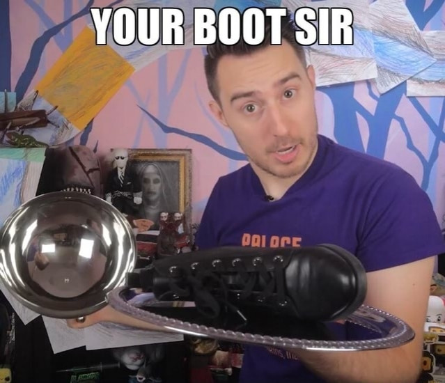 James A. Janisse holding a silver tray with a boot on it. Caption says "Your boot sir"