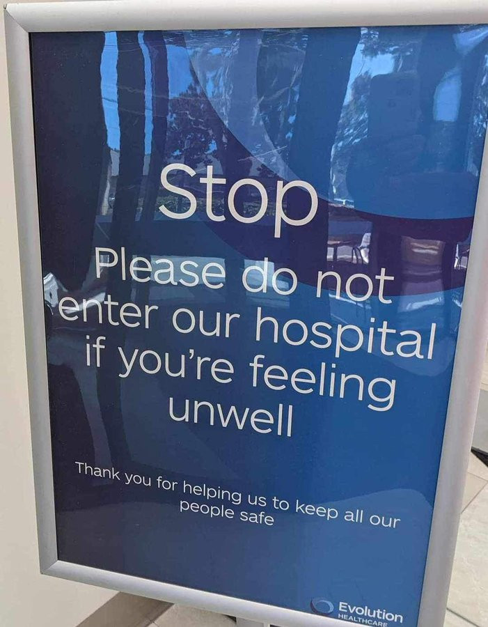 Sign saying:
Stop
Please do not enter our hospital if you're feeling unwell
Thank you for helping us to keep all our people safe