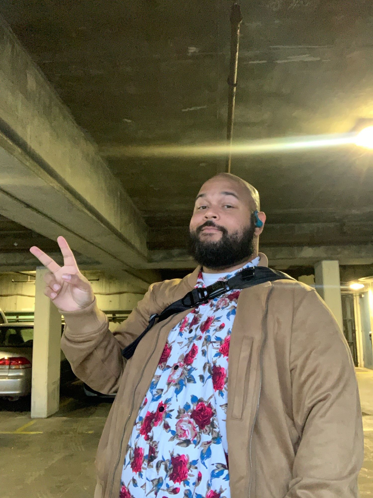 User bearickson poses in a selfie with a peace sign and a smirk in a garage