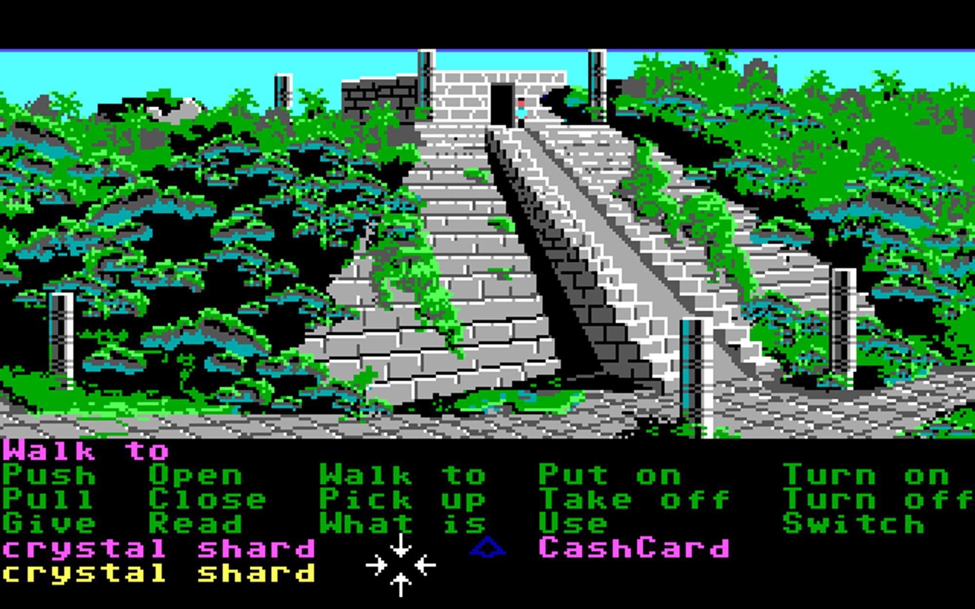 Screenshots of the DOS V2 version of Zak McKracken, with Annie picking up the crystal shard from Mexico while already having one in her inventory. In the Commodore 64 and DOS V1 releases, this causes a bug where one of the shards disappears, softlocking the game. Later versions fixed this bug. However, the DOS V2 version does have a bug where Annie's tiny sprite outside the pyramid uses Zak's sprite by mistake, an error not present in the C64, DOS V1, or FM Towns versions.