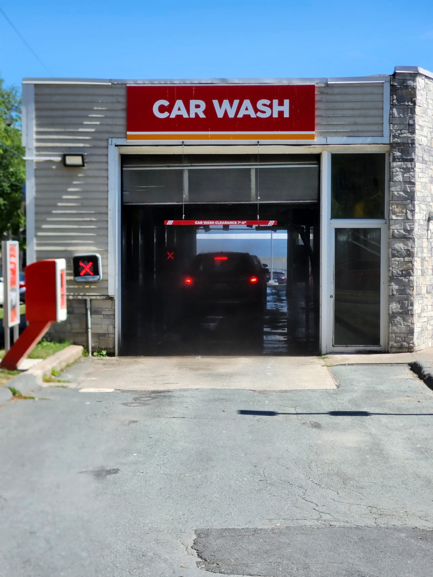 Open car wash, with two cars in. 