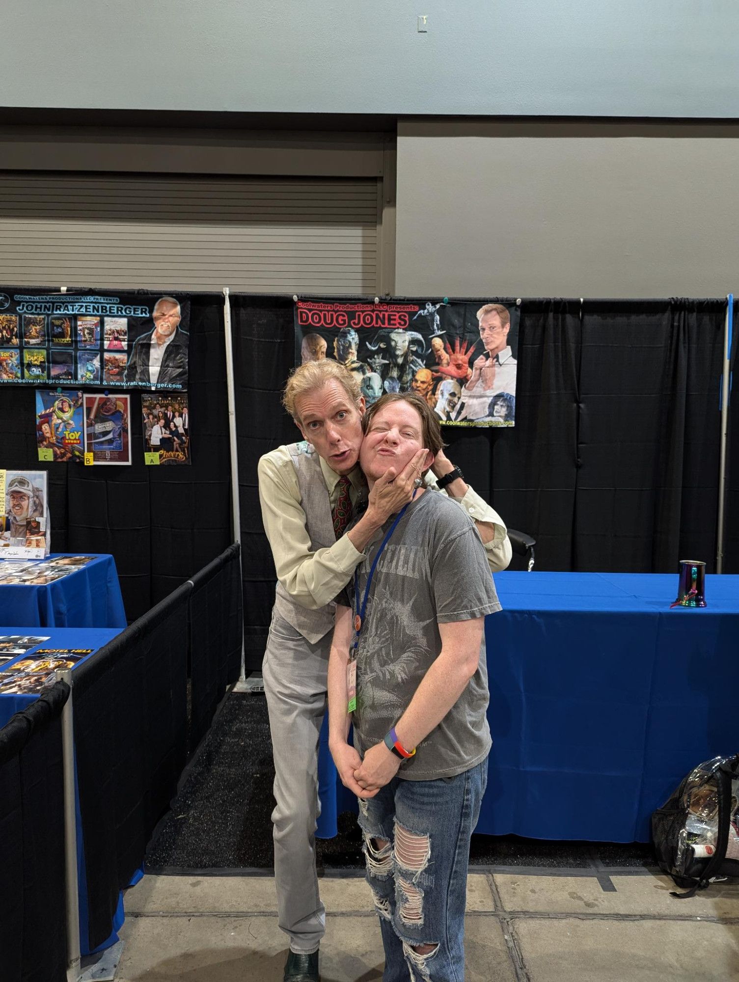 A photo of me with Doug Jones! He's holding my face and we're making silly faces.