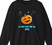 Cute Halloween sweatshirt featuring a very happy and possibly slightly drunk pumpkin with the words "I'm just here for the boos" spelled like the ghost sound of "boo" Designed by Retnoob at https://www.etsy.com/shop/Retnoob