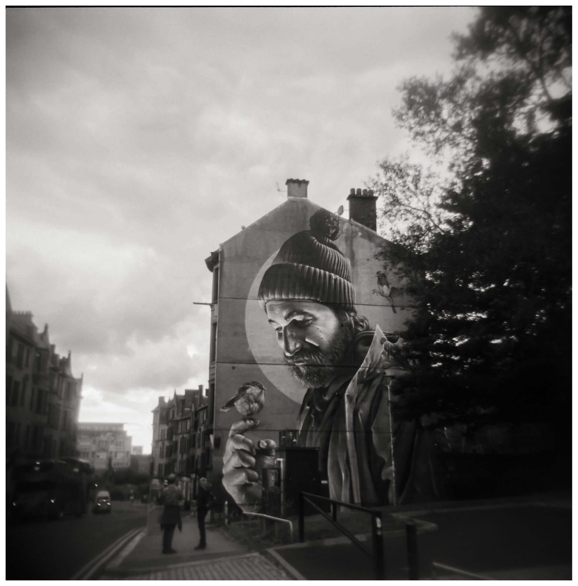 A black & white photo of the St Mungo & Robin  mural in Glasgow