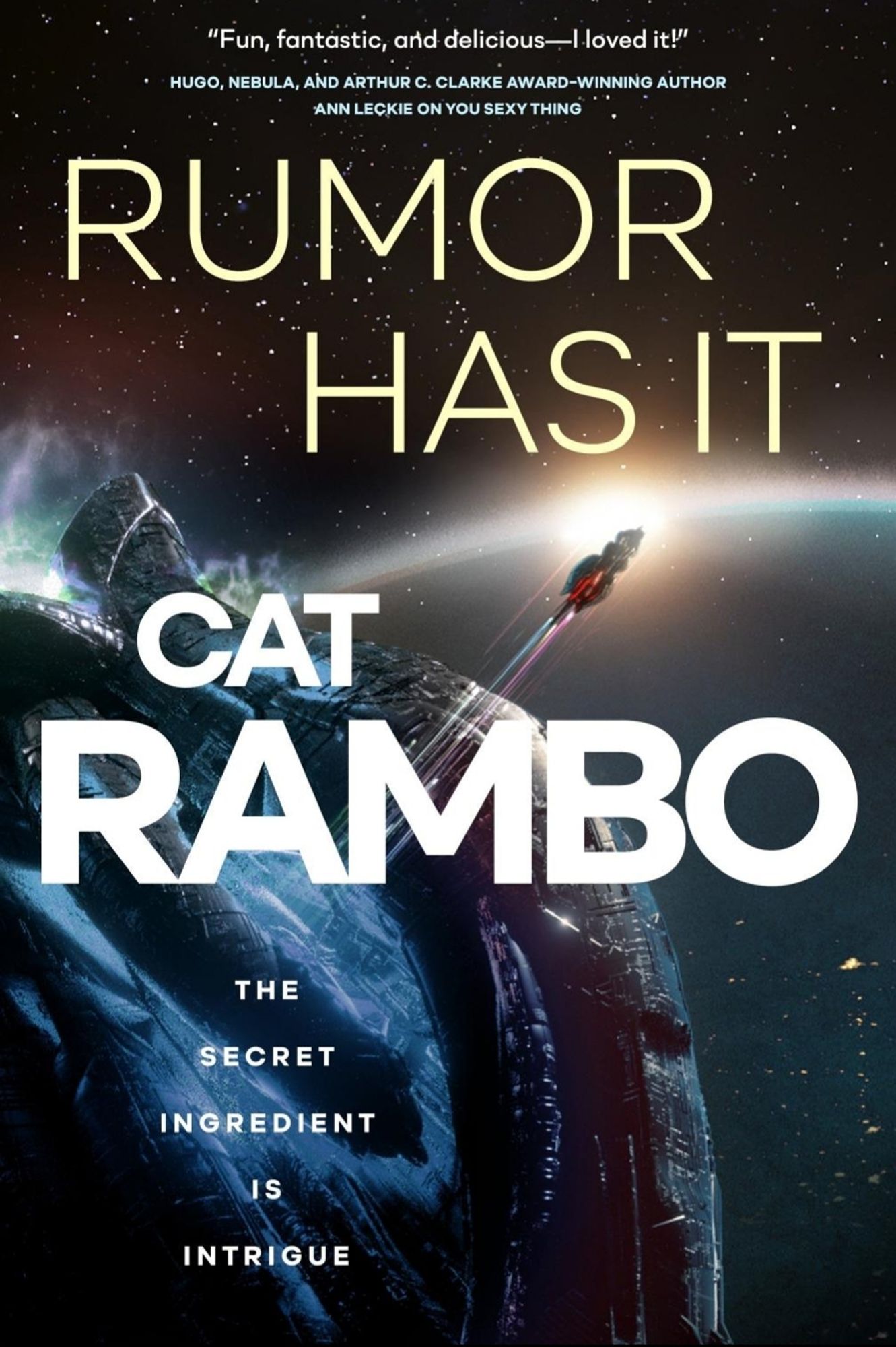 The cover of RUMOR HAS IT, by Cat Rambo, depicts a space ship shooting away from a large terrestrial object. The tagline reads "the secret ingredient is intrigue," and the cover blurb from Ann Leckie says the first book in the series was "fun, fantastic and delicious."