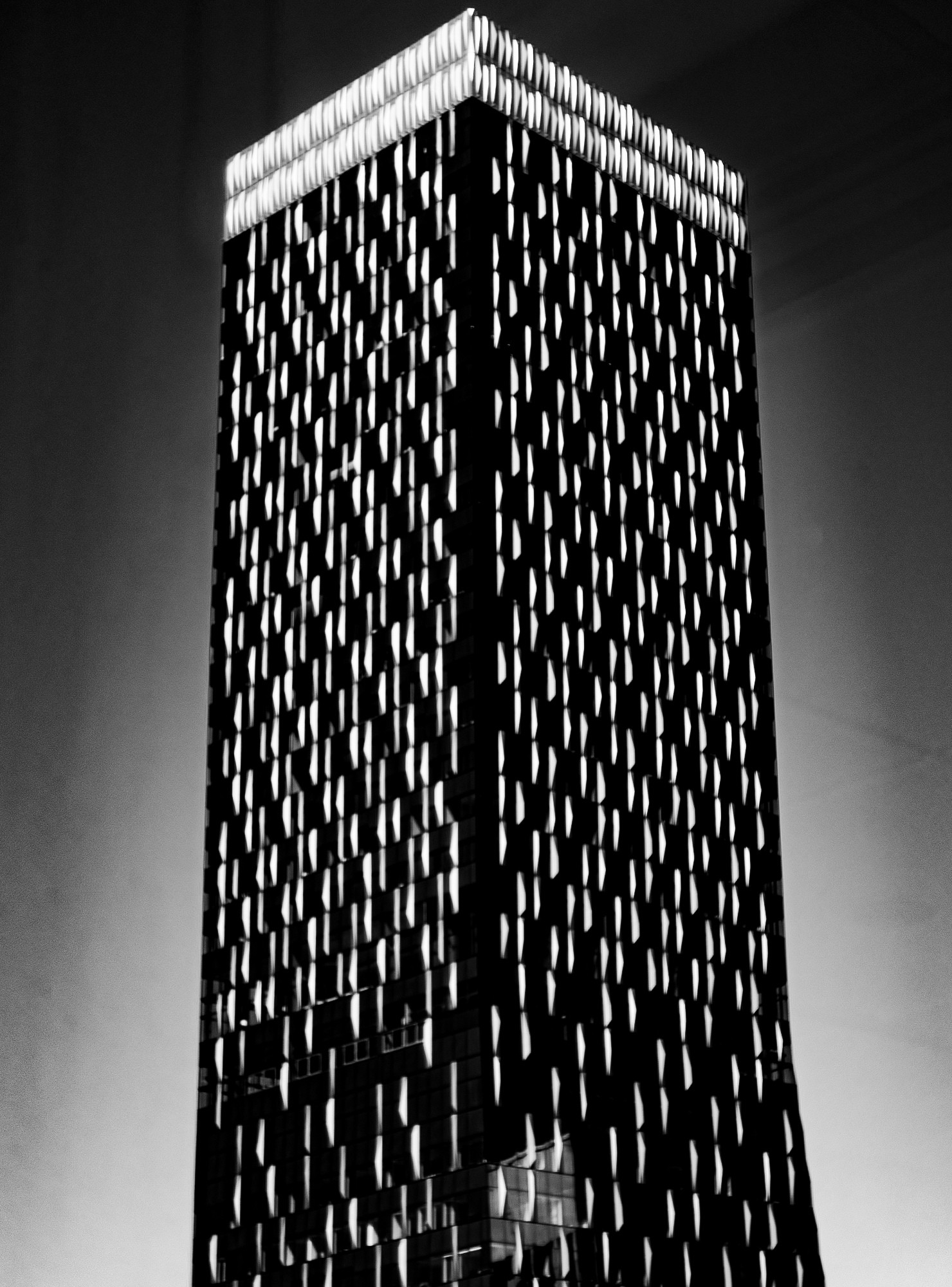 black & white photo of the top of a skyscraper