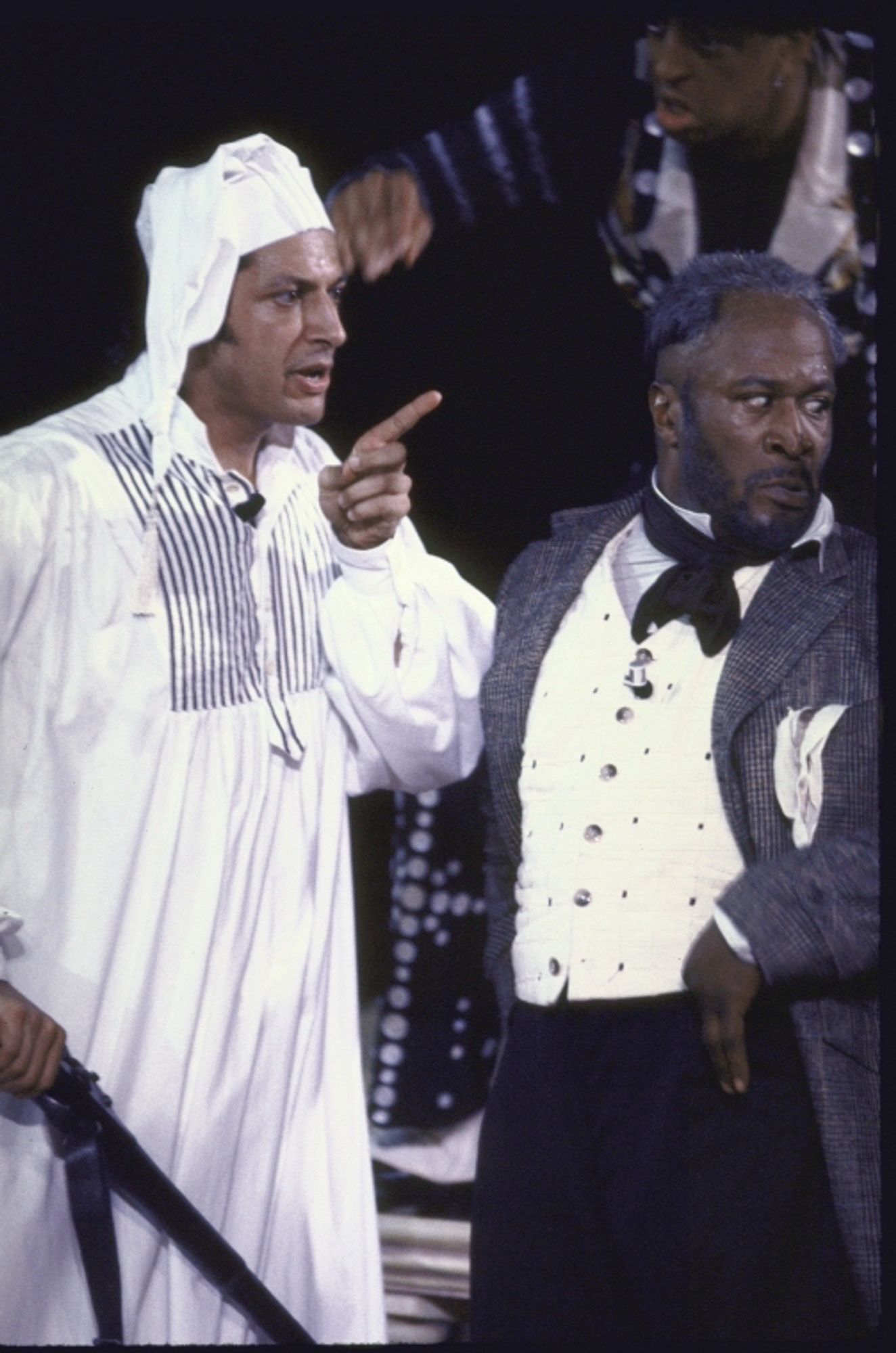 Goldblum in a nightcap & nightgown, & John Amos in a three-piece suit, onstage