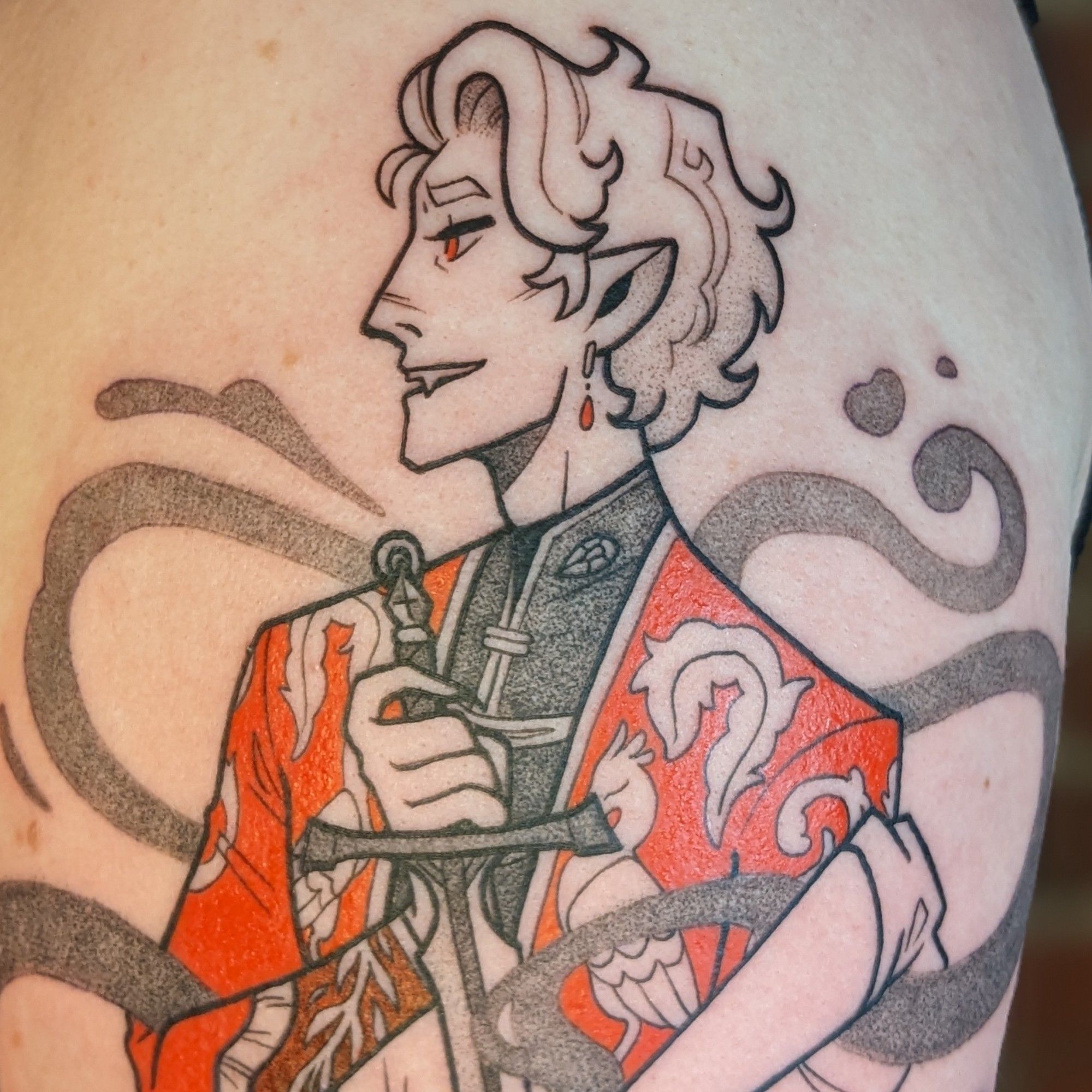 A tattoo of Astarion from Baldur's Gate 3. Spoilers ahead! It is a playing card/rotationally mirrored design that plays with his two plot endings. The top is the ascended Astarion, happy and cruel, in a fancy, embroidered red jacket. The bottom is Astarion denied and covered in blood. Sad but feeling. Ascended Astarion holds the hilt of the sword of life stealing, which points to the throat of the reverse Astarion, whose hand caresses the blade. The second photo is a close up of ascended Astarion, the third photo is a close up of the reverse Astarion.