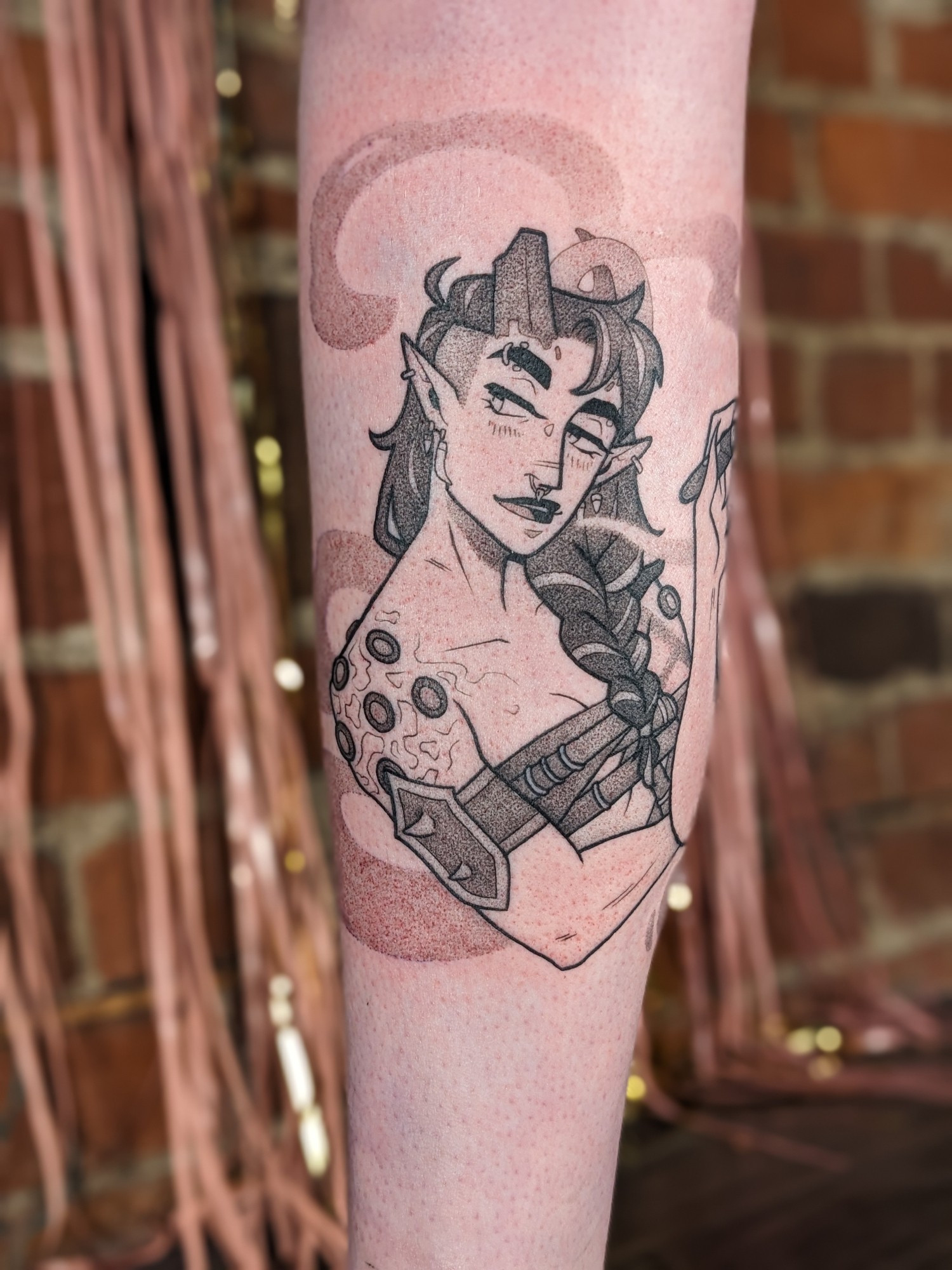 A black & grey tattoo of Karlach from Baldur's Gate 3. It hints at her ending where she is smoking a cigar. She looks over her shoulder, cheeky and satisfied. She is surrounded by smoke.