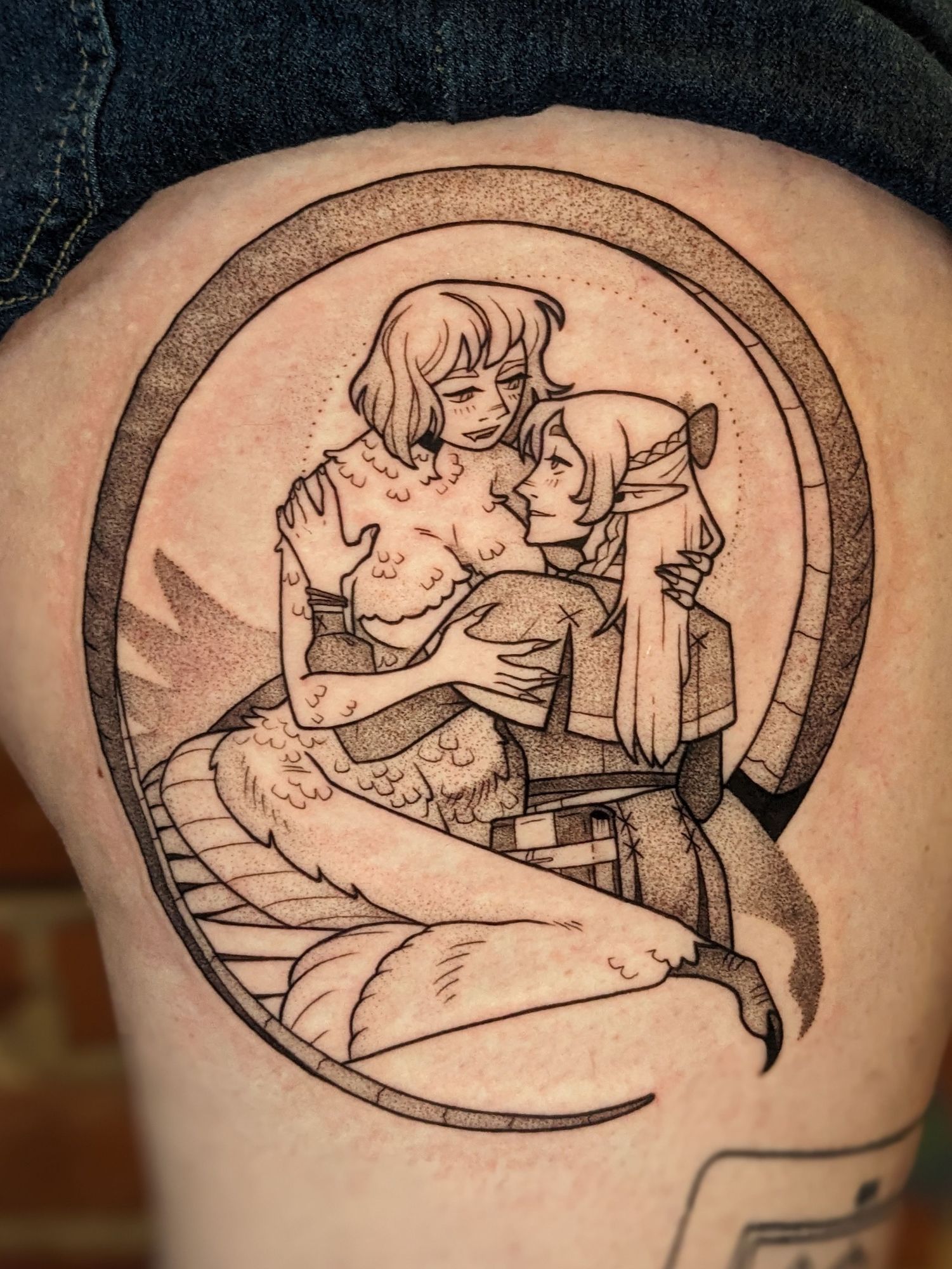 A black and grey tattoo of Chimera Falin and Marcille from Dungeon Meshi being obvious girlfriends. They are looking at each other adoringly, and Falin's wing is wrapped around Marcille. The tail frames the portrait.