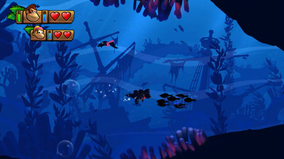 Screenshot of Tropical Freeze level "Amiss Abyss" showing a silhouetted Donkey Kong and Dixie Kong swimming through a stylish underwater scene of kelp, anemones, and sunken shipwrecks.