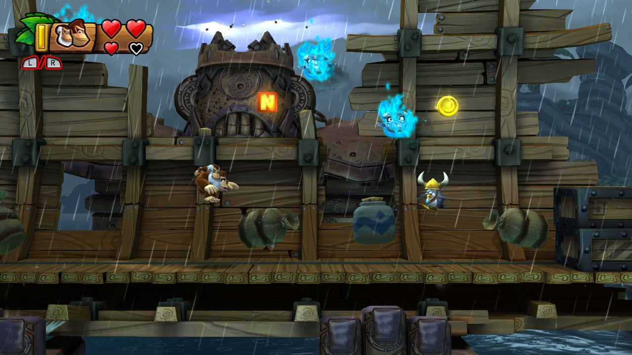 Screenshot of level "Rockin' Relics" depicting DK and Cranky Kong journey through a thunderstorm, traversing the remains of a large ship, which is clutched in the arms of a giant mechanical titan, that twitches when lightning gives it a brief pulse of power, causing the wreckage to shake violently.