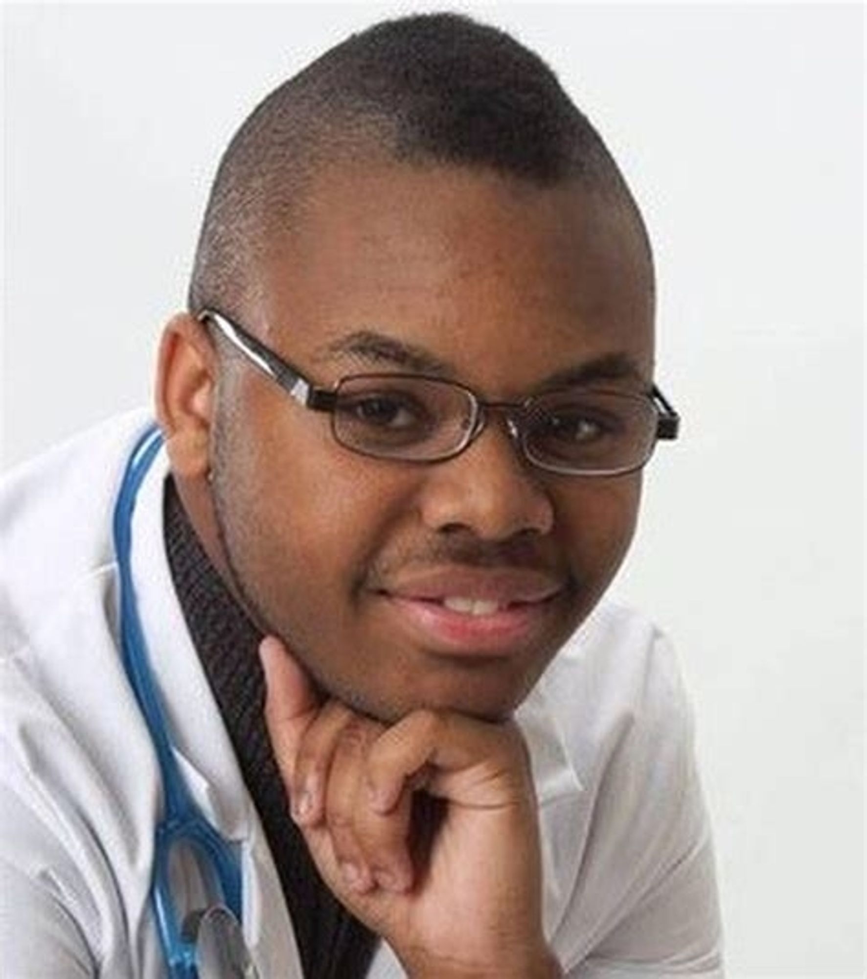 Malachi Love-Robinson posing in white doctor's scrubs