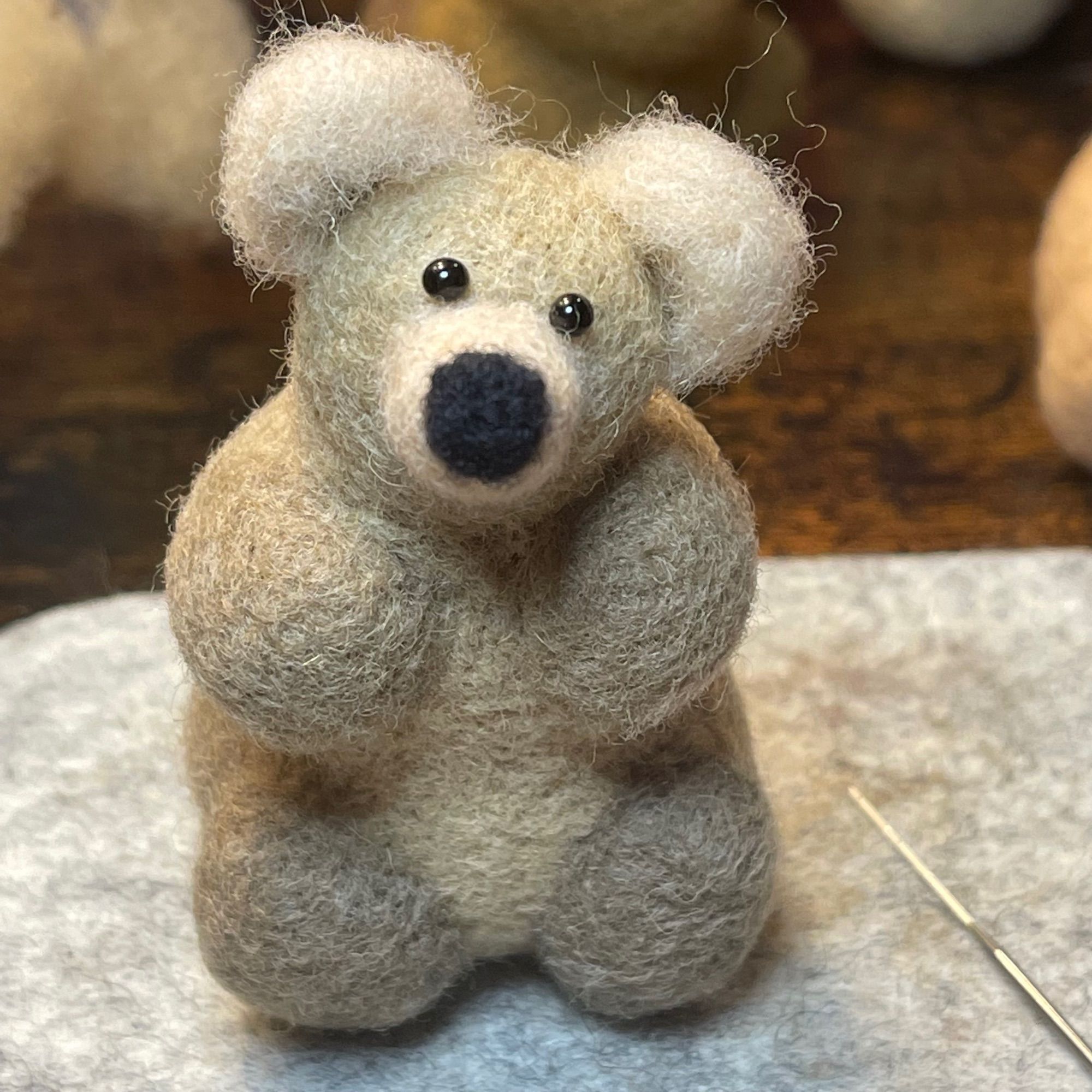 A photo of a work in progress. Needle felted yearling bear (approximately 2.5 years old). Bear 428 Studious, one of Bear 128 Grazer’s 2020 twins.)