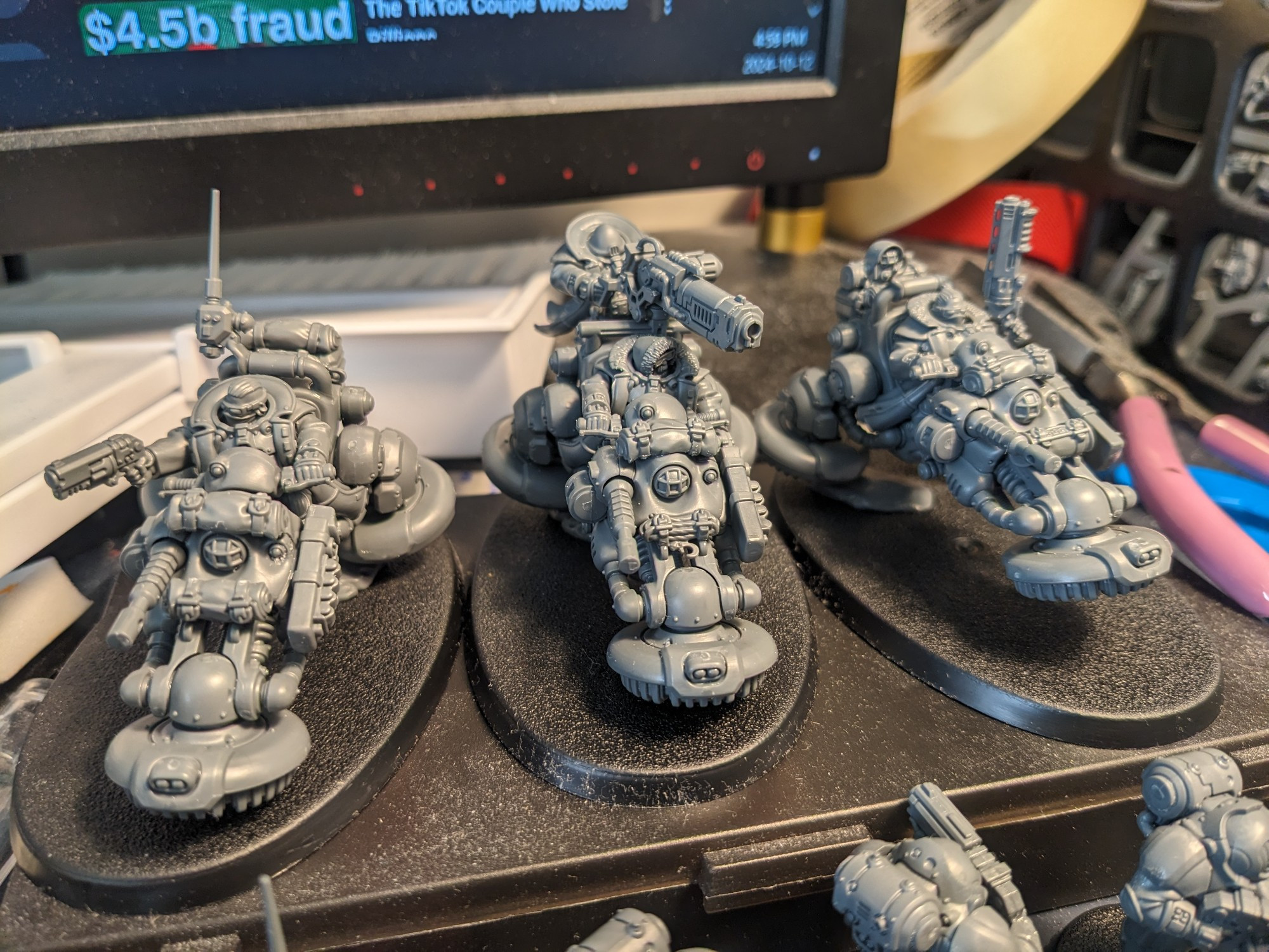 a close up of three unpainted models of Pioneers, biker units of Votann from Warhammer 40k